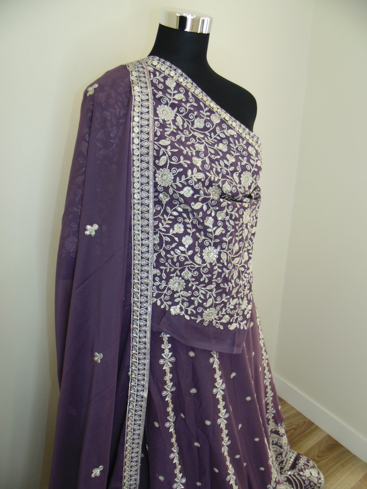 Purple Lehenga with golden zari floral patterns on a white background