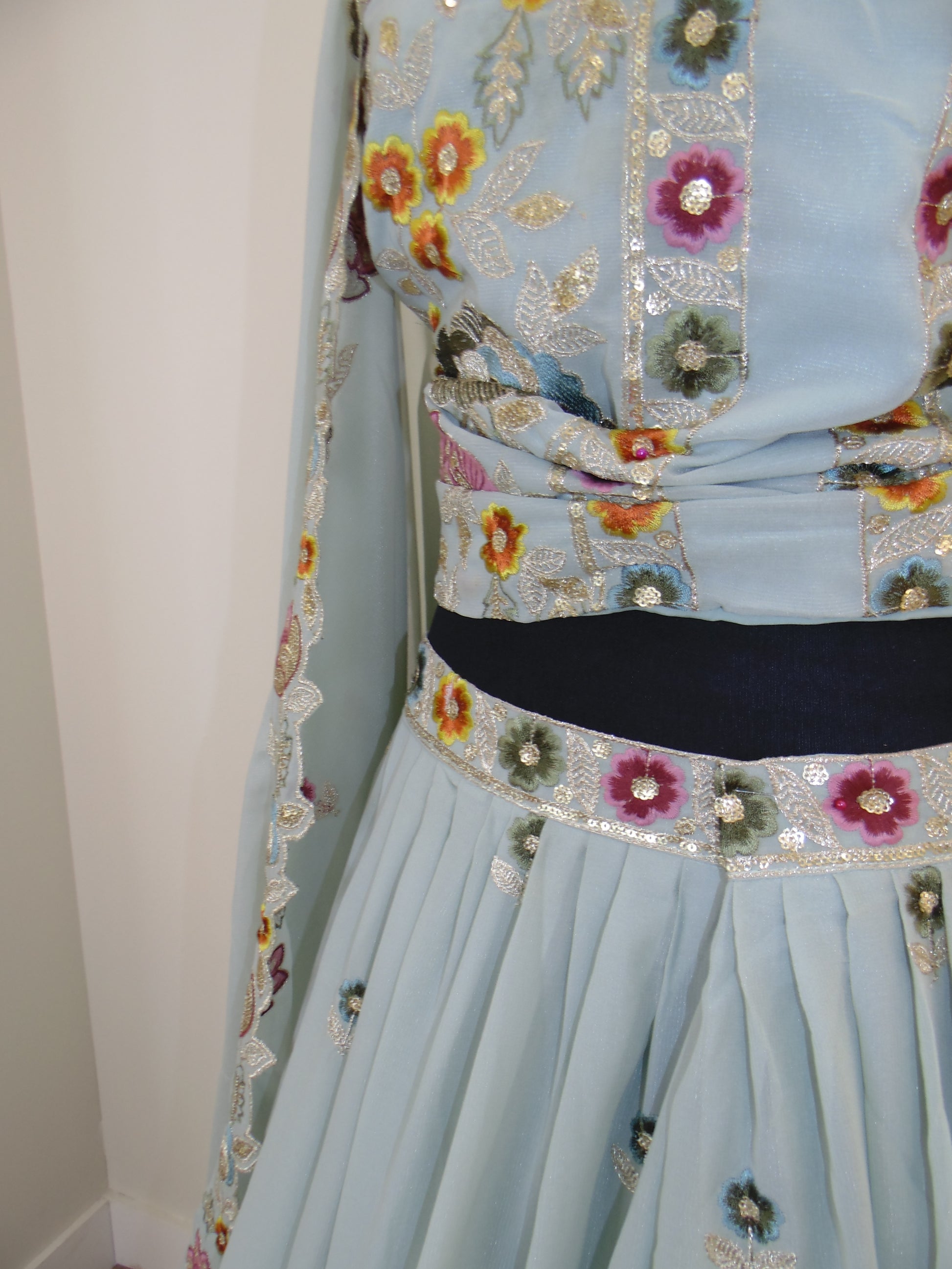 Light blue fabric with floral embroidery on a white background