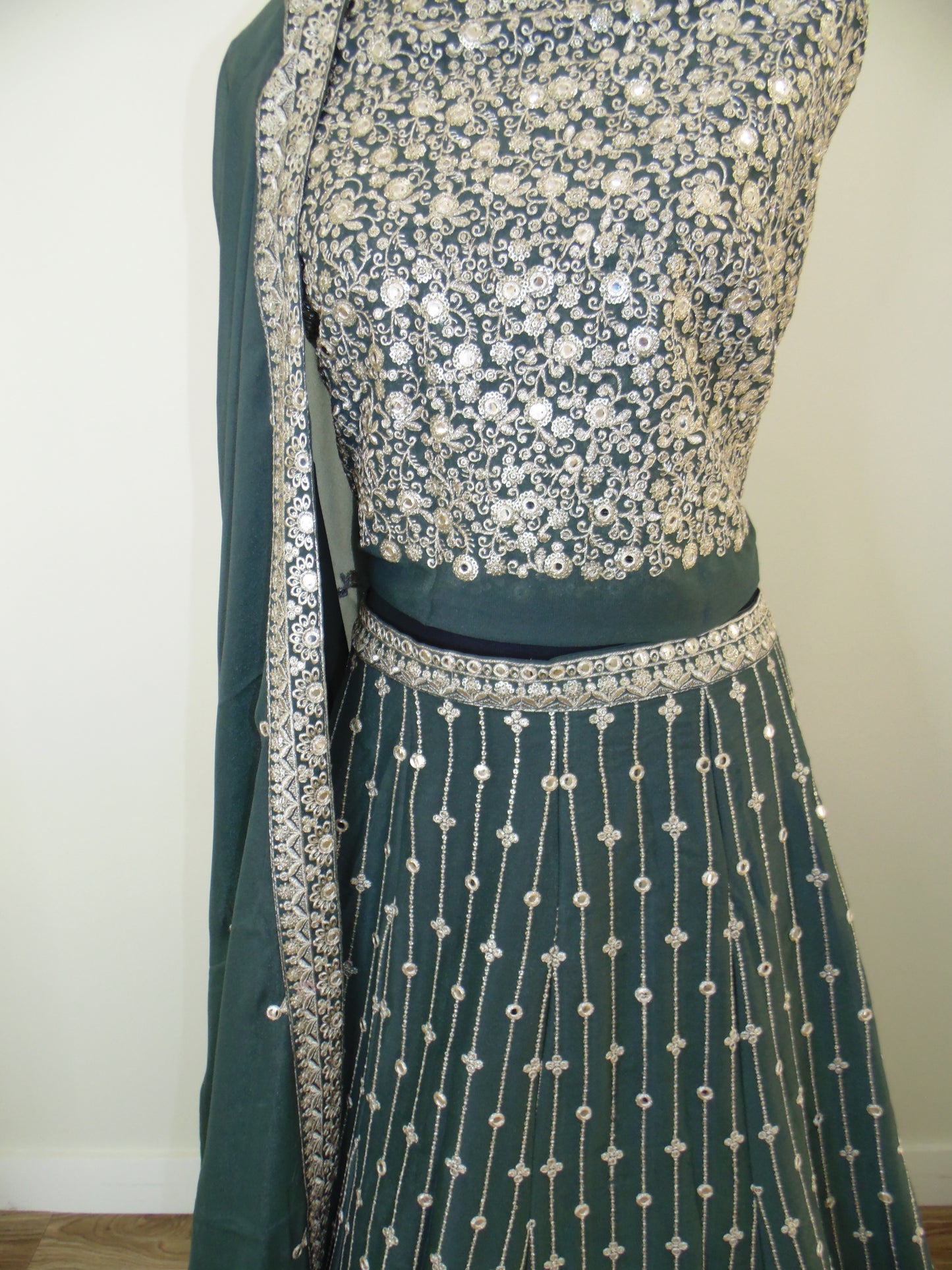 Indian Lehenga on a mannequin against a plain background