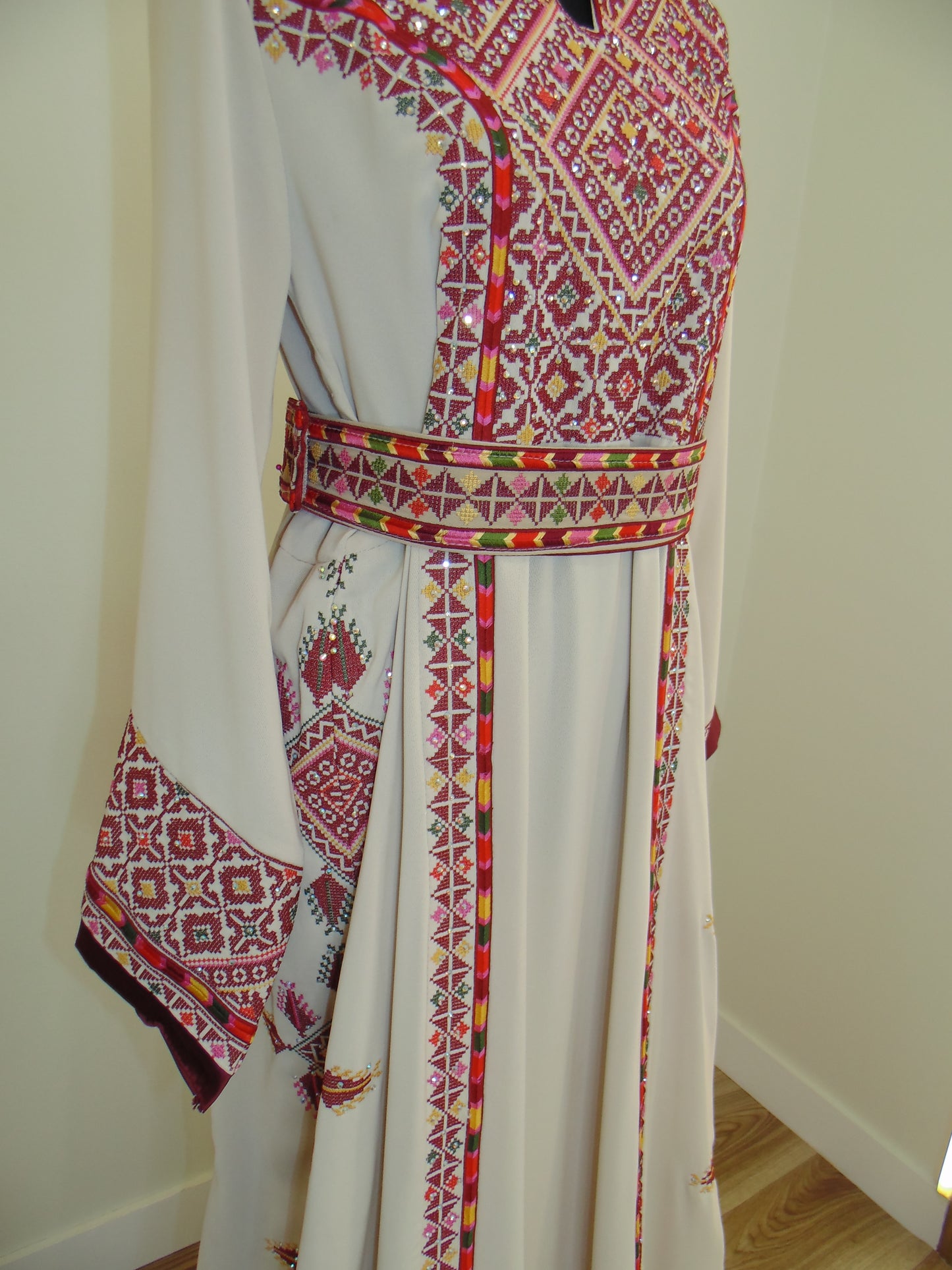 Traditional embroidered fabric with intricate patterns on a white background
