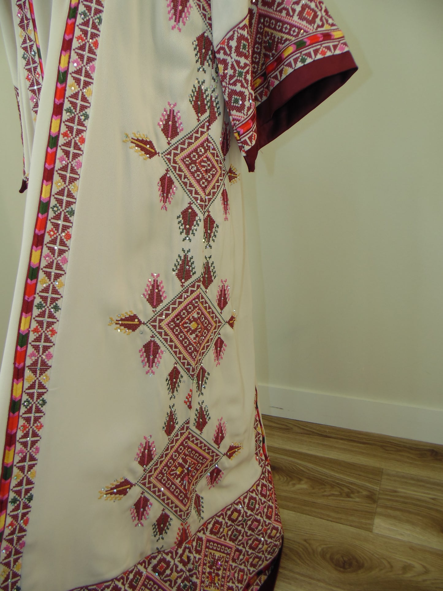 Palestinian Tatreez Embroidered fabric with geometric patterns on a plain background
