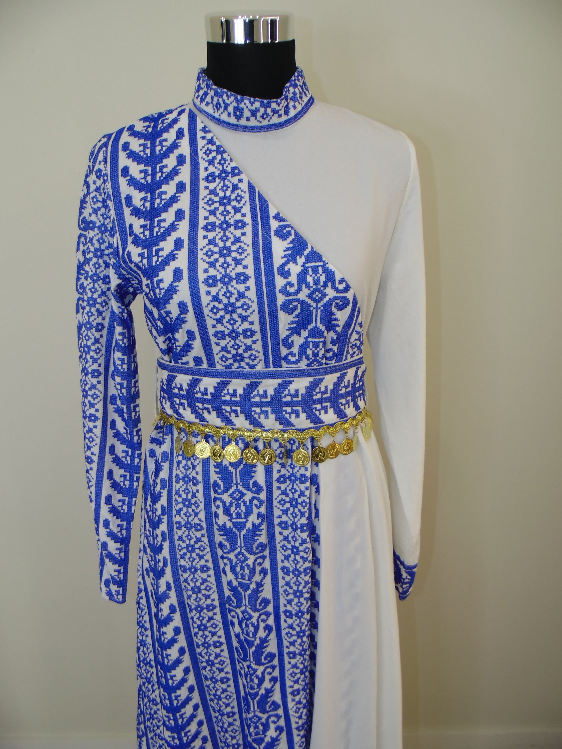 Traditional garment with blue and white patterns on a plain background