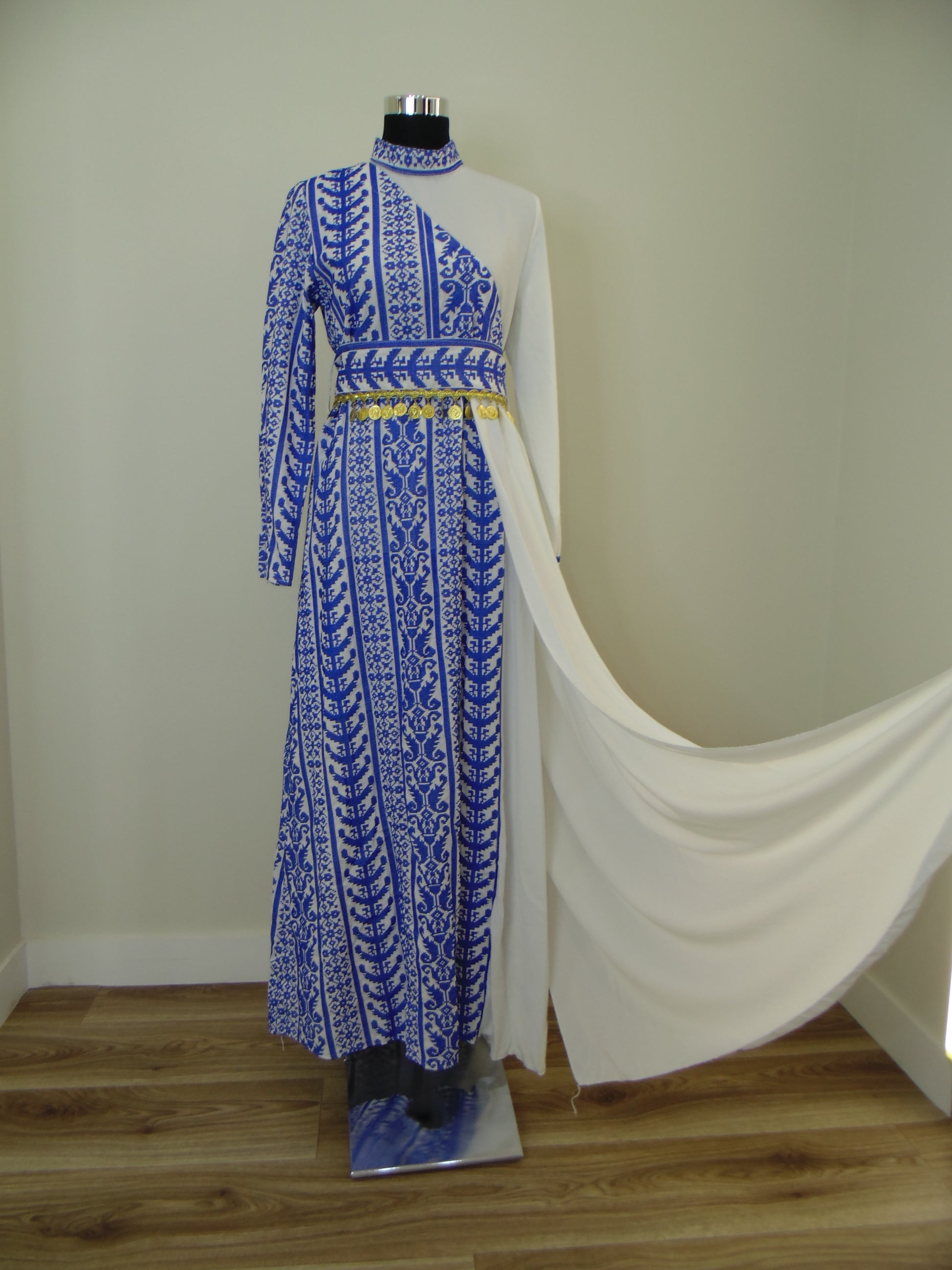 Blue embroidered Palestinian Thobe  on a mannequin against a neutral background