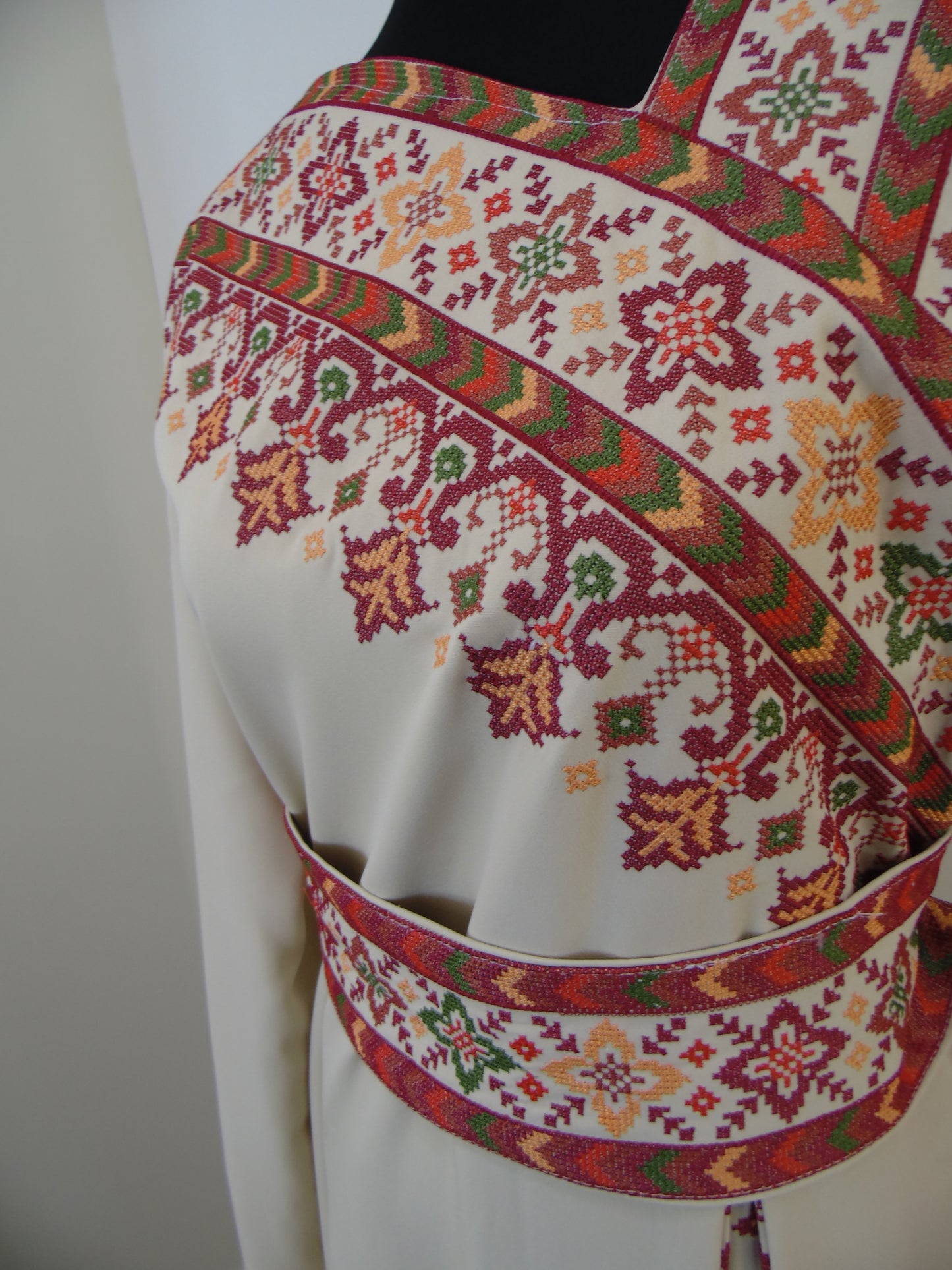 Embroidered fabric with colorful patterns on a plain background