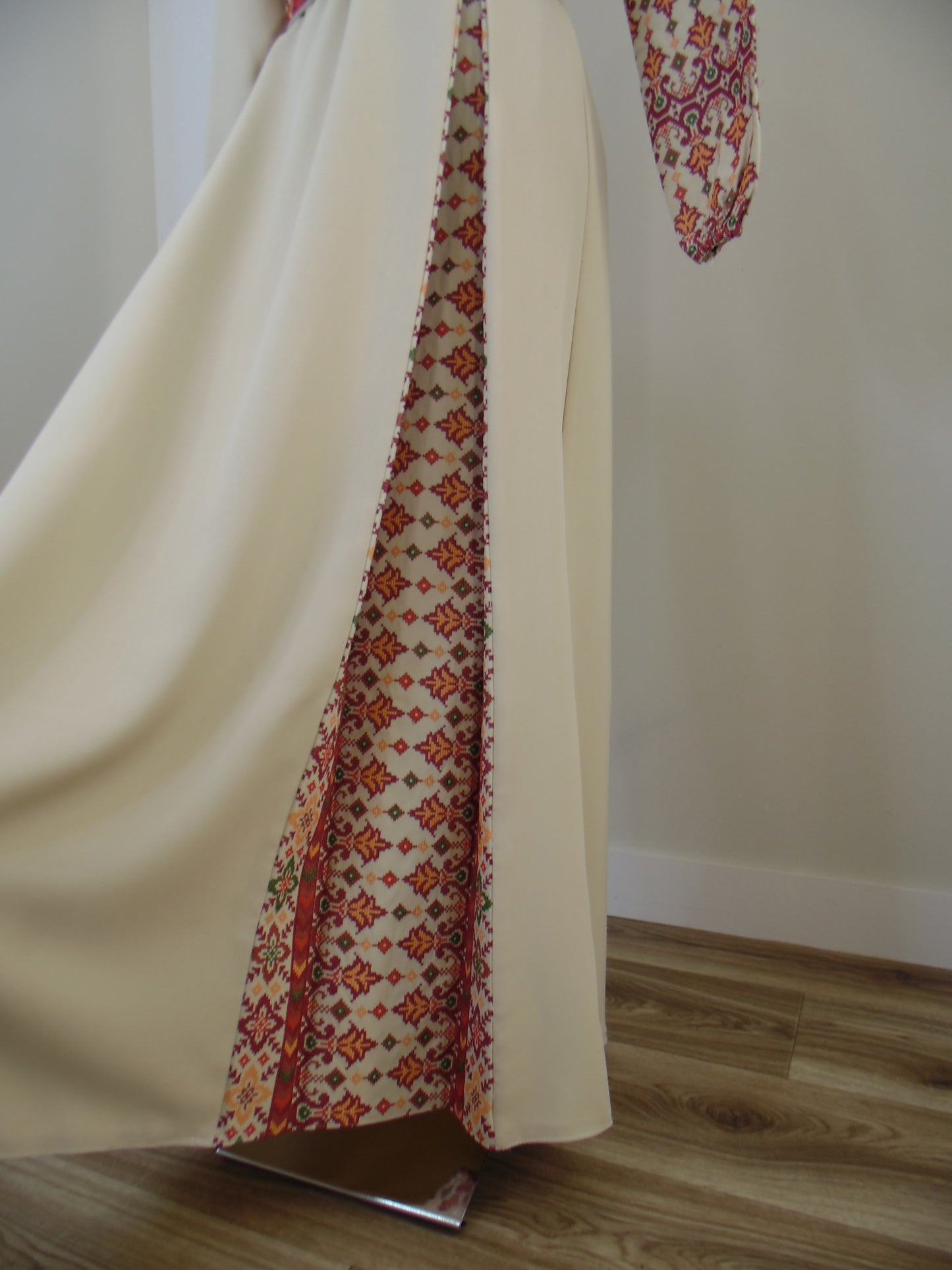 Fabric with a patterned border draped over a surface