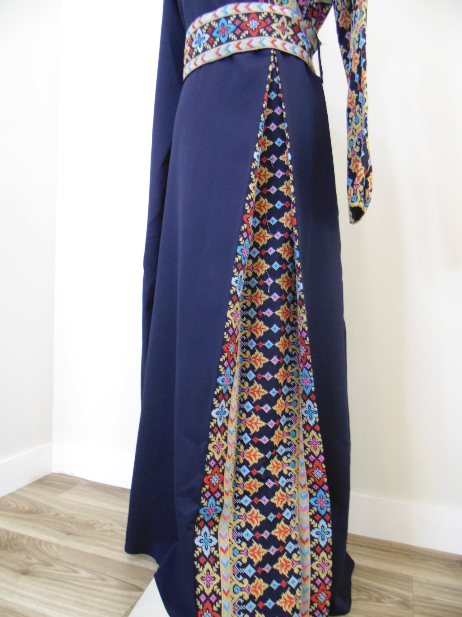 Navy blue fabric with colorful geometric patterns on a white background