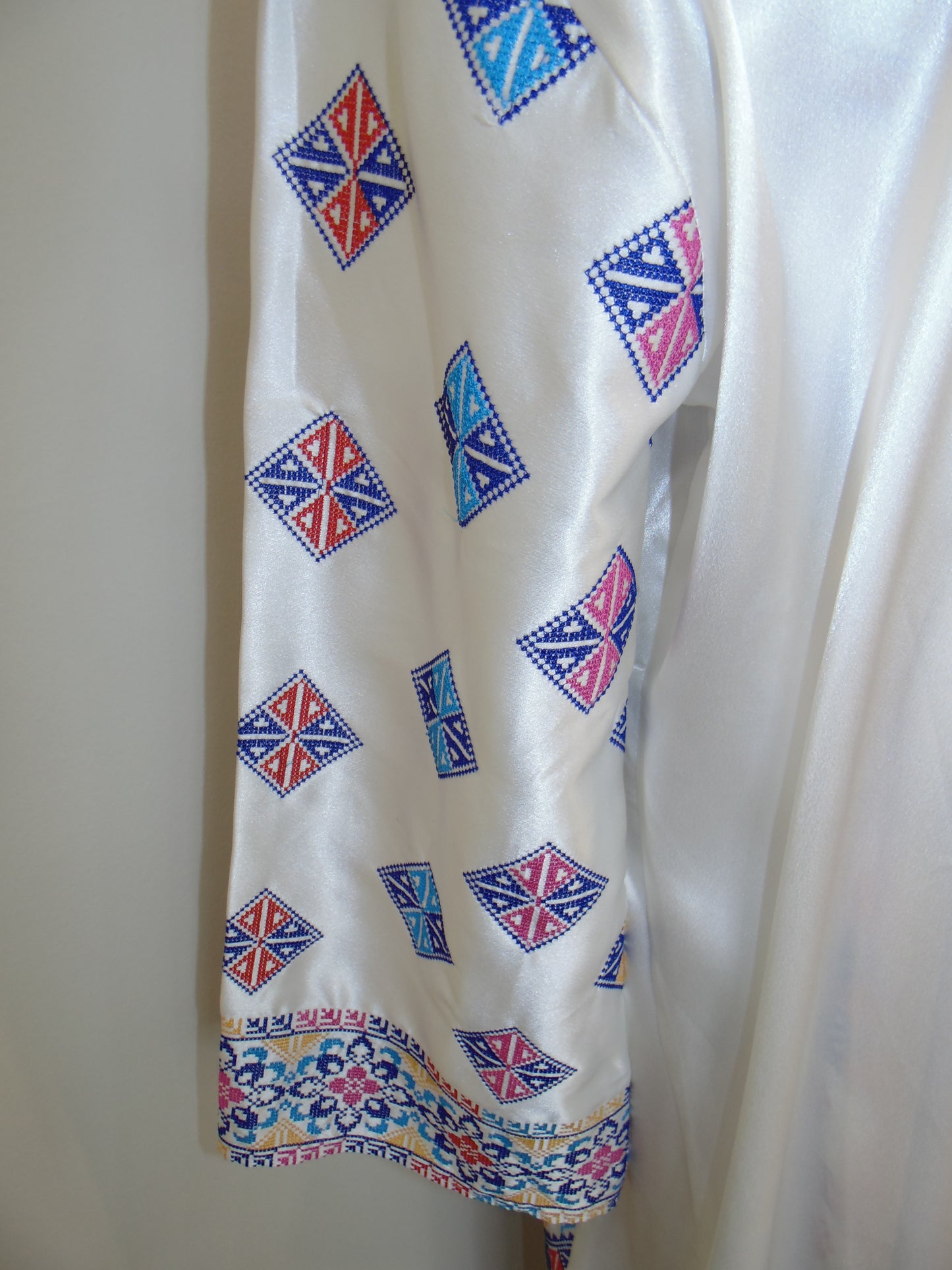 White fabric with blue and red geometric pattern