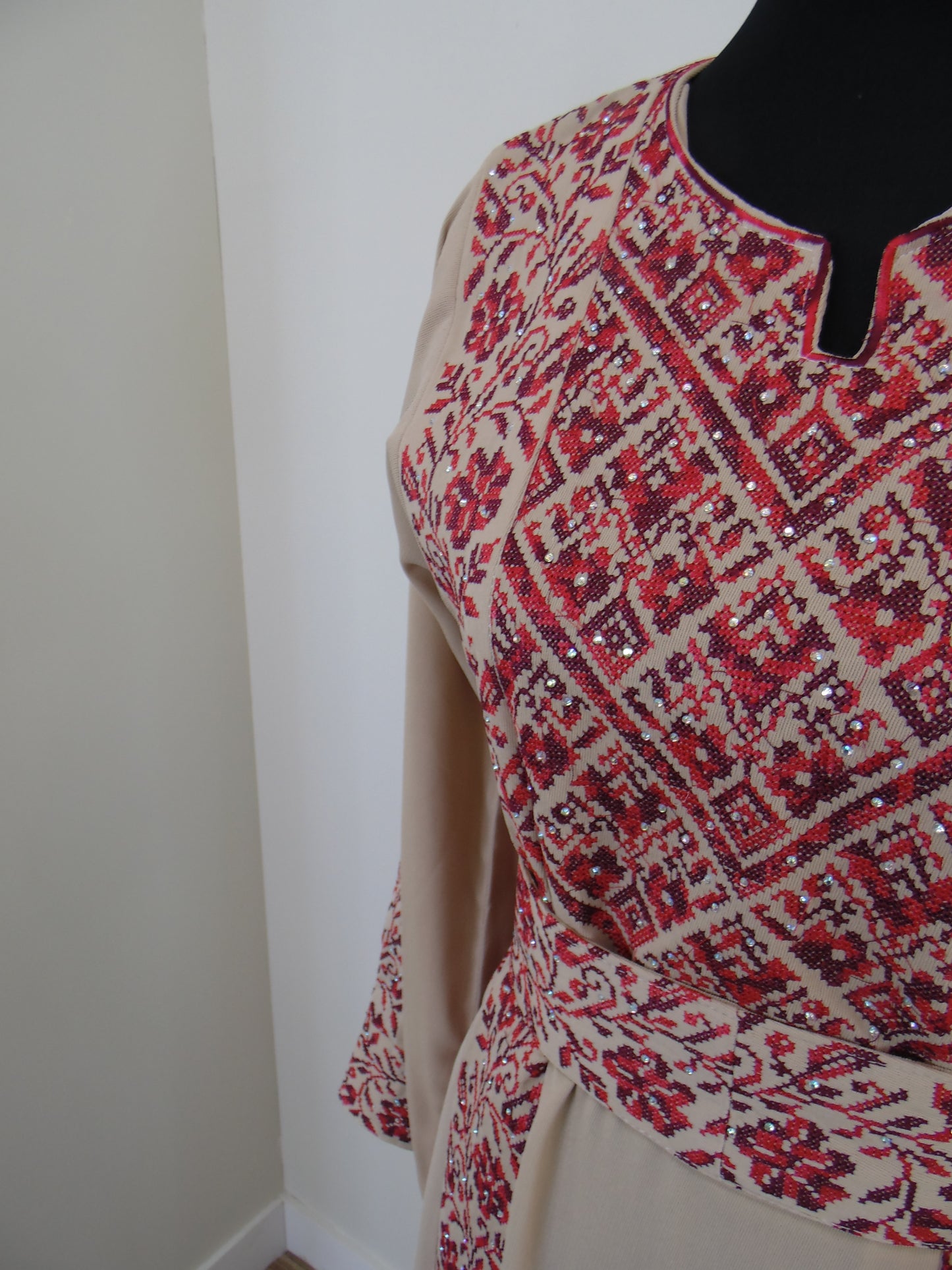 Red and white patterned fabric draped over a black object on a white background