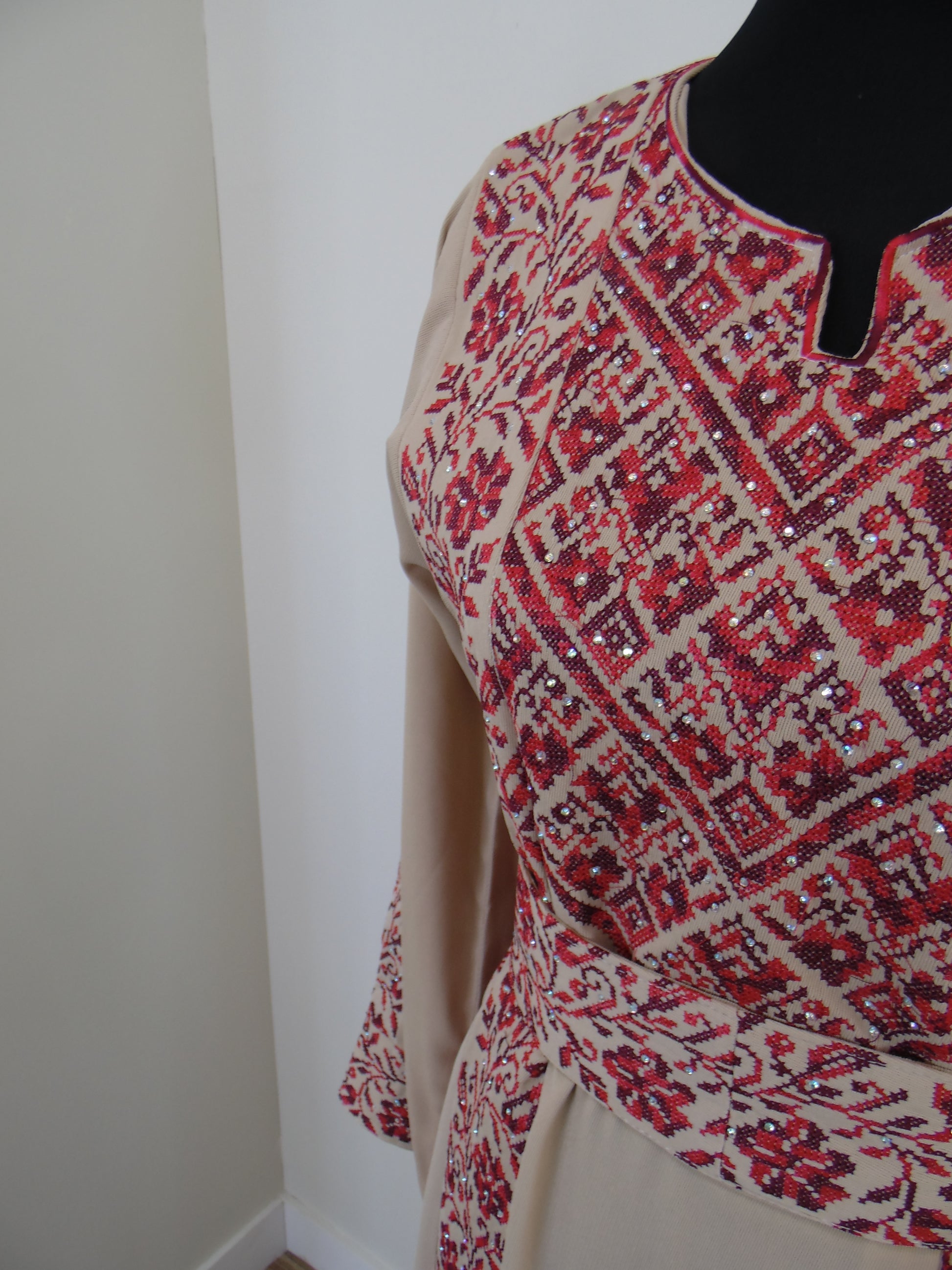 Red and white patterned fabric draped over a black object on a white background