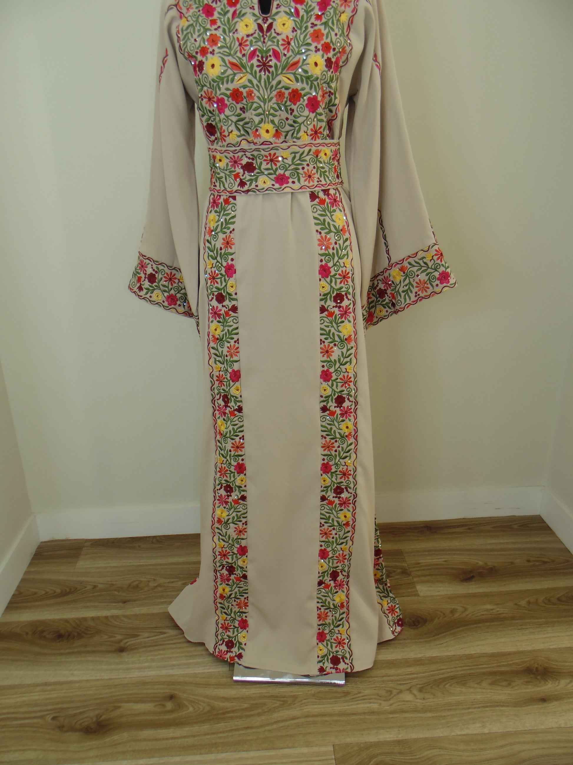 Floral-patterned fabric draped over a wooden surface with a neutral wall background