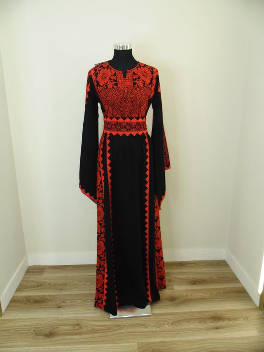 Red and black patterned garment on a mannequin in a store setting