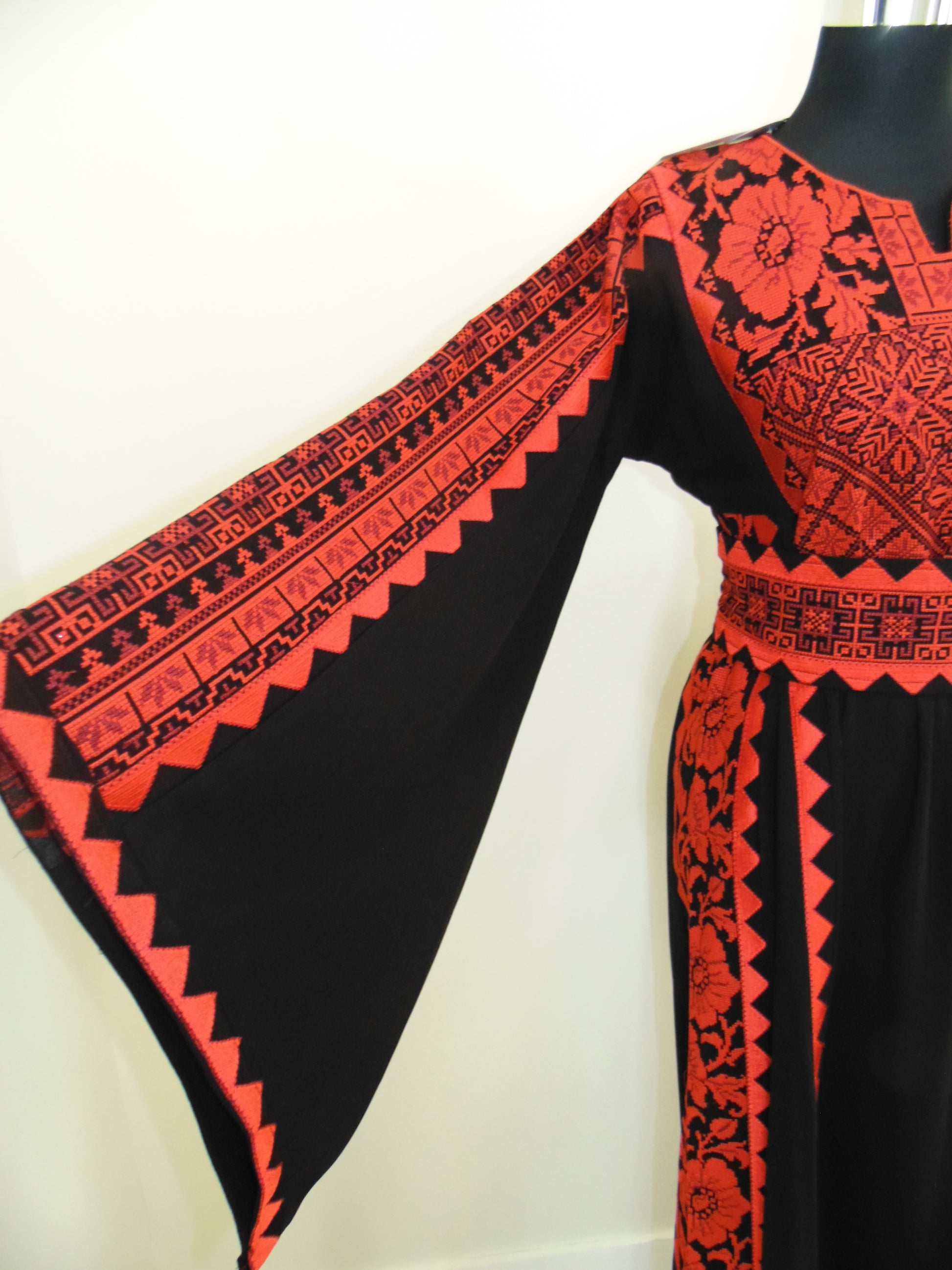 Black fabric with red and white pattern on a white background