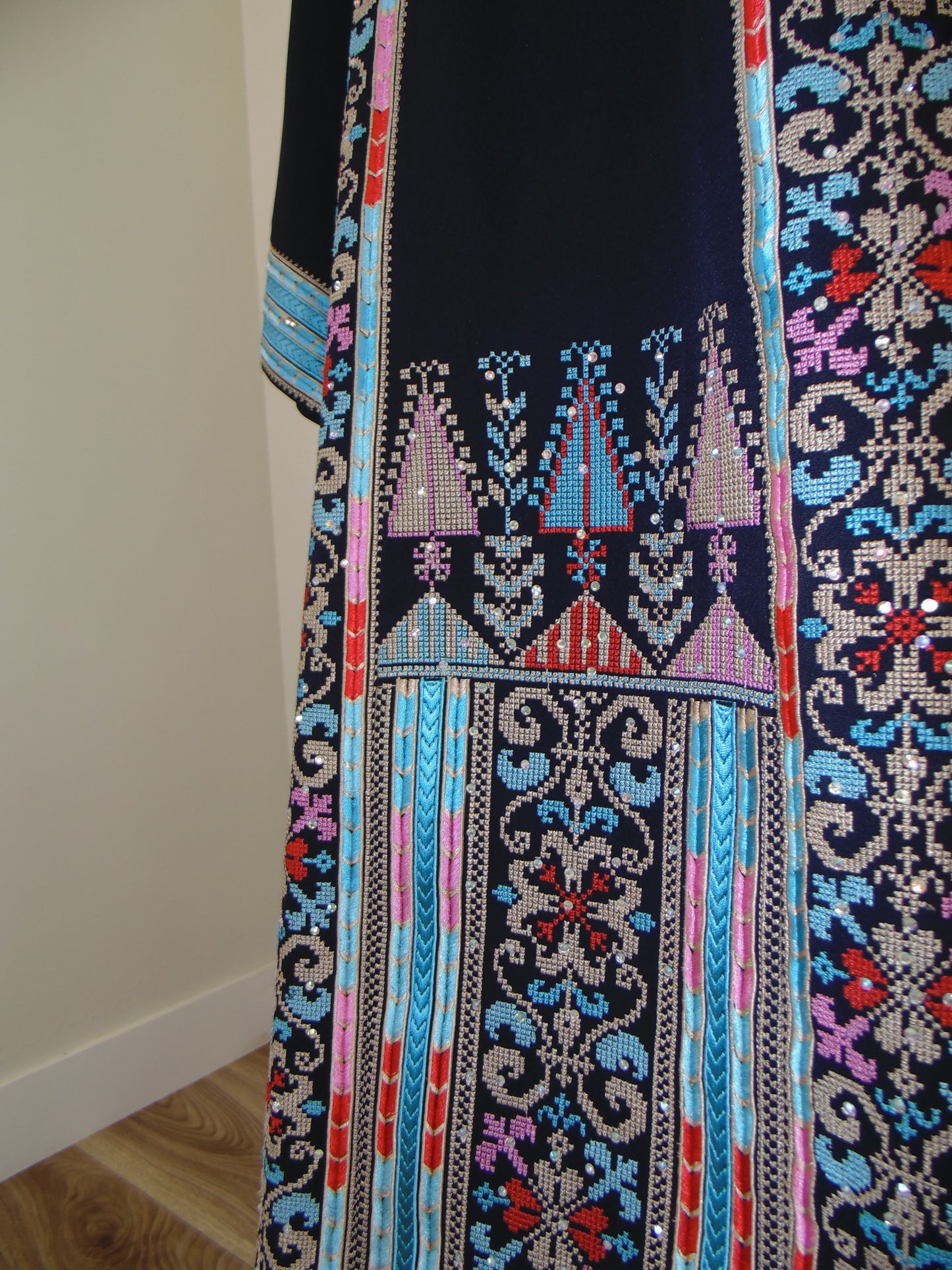 Embroidered fabric with intricate patterns on a white background