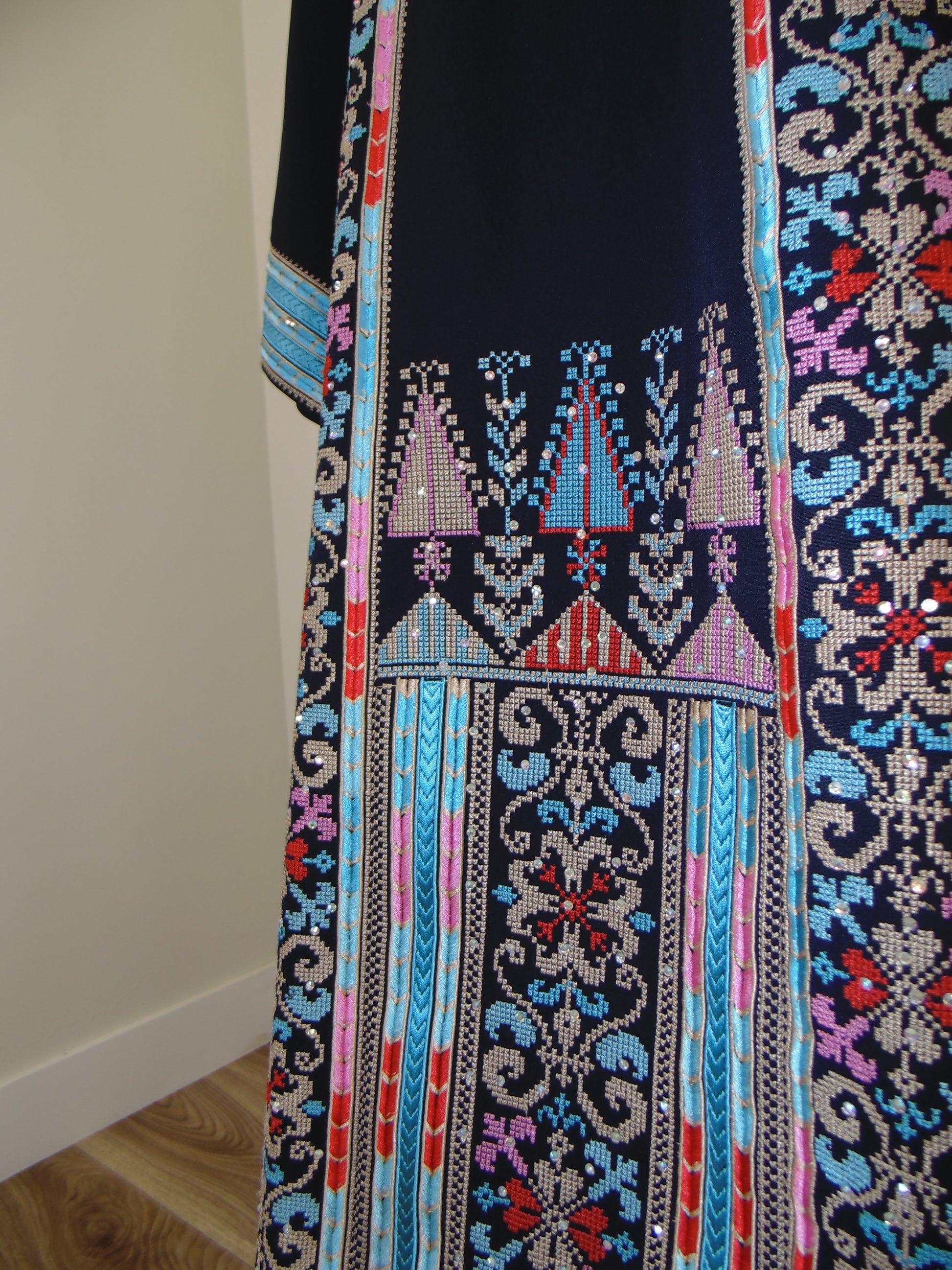 Embroidered fabric with intricate patterns on a white background