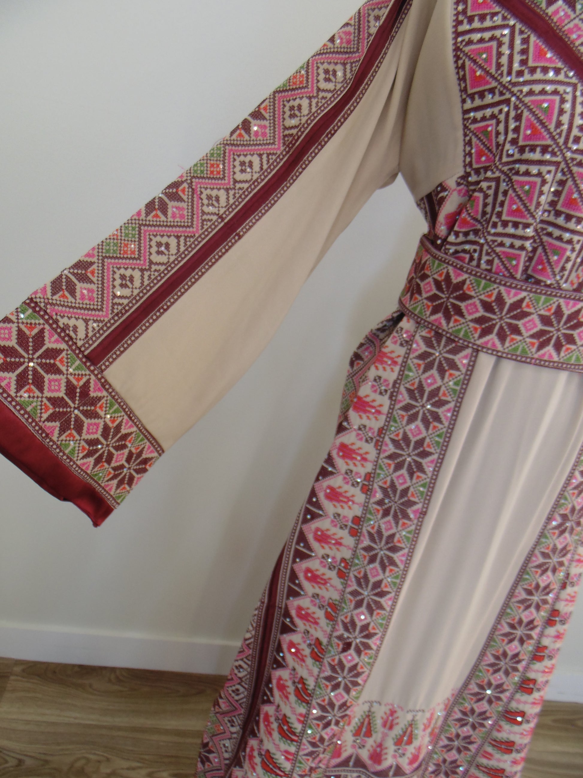 Traditional embroidered fabric with intricate patterns on a plain background