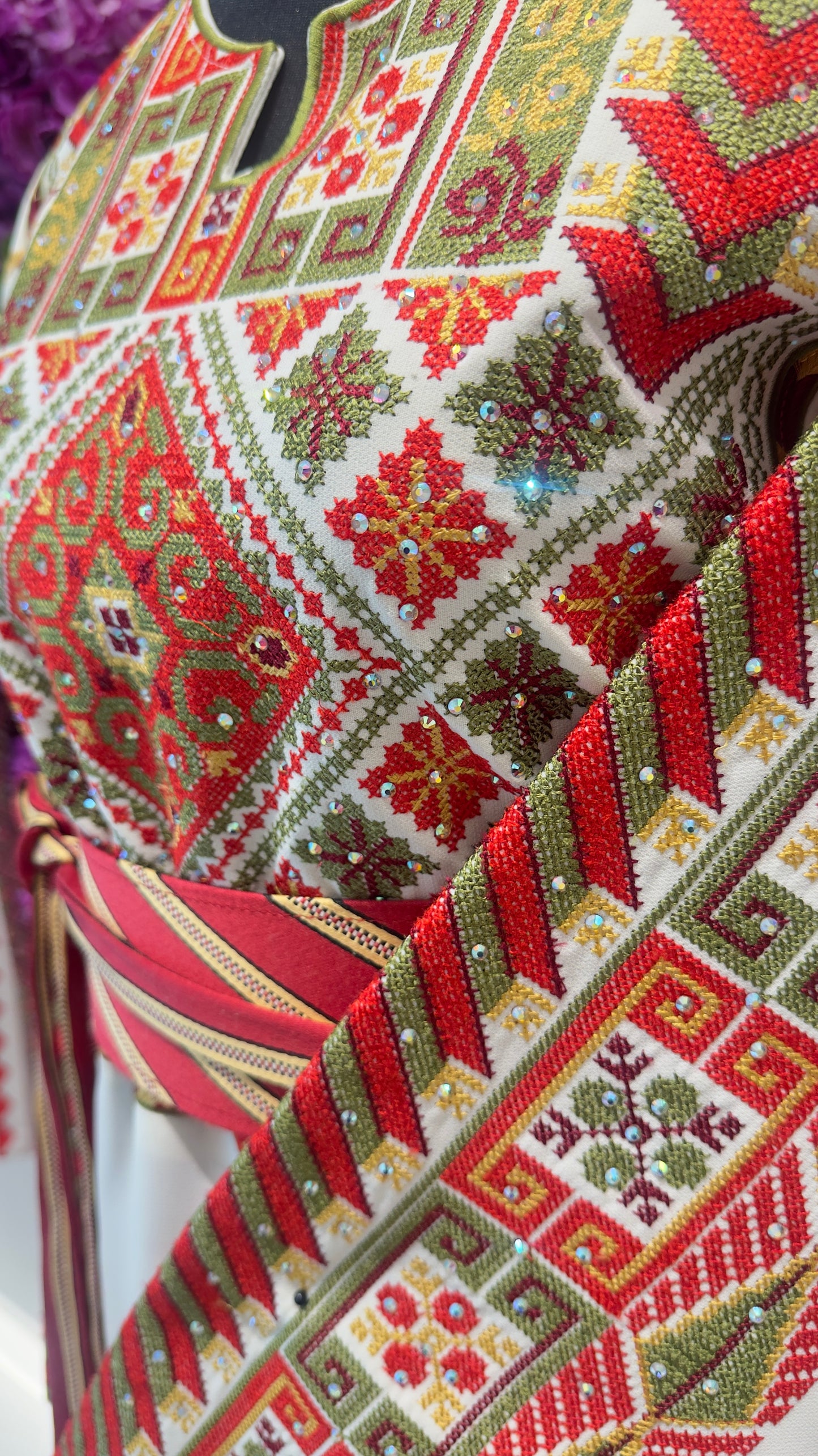 Close-up of a patterned fabric with red, green, and white colors.