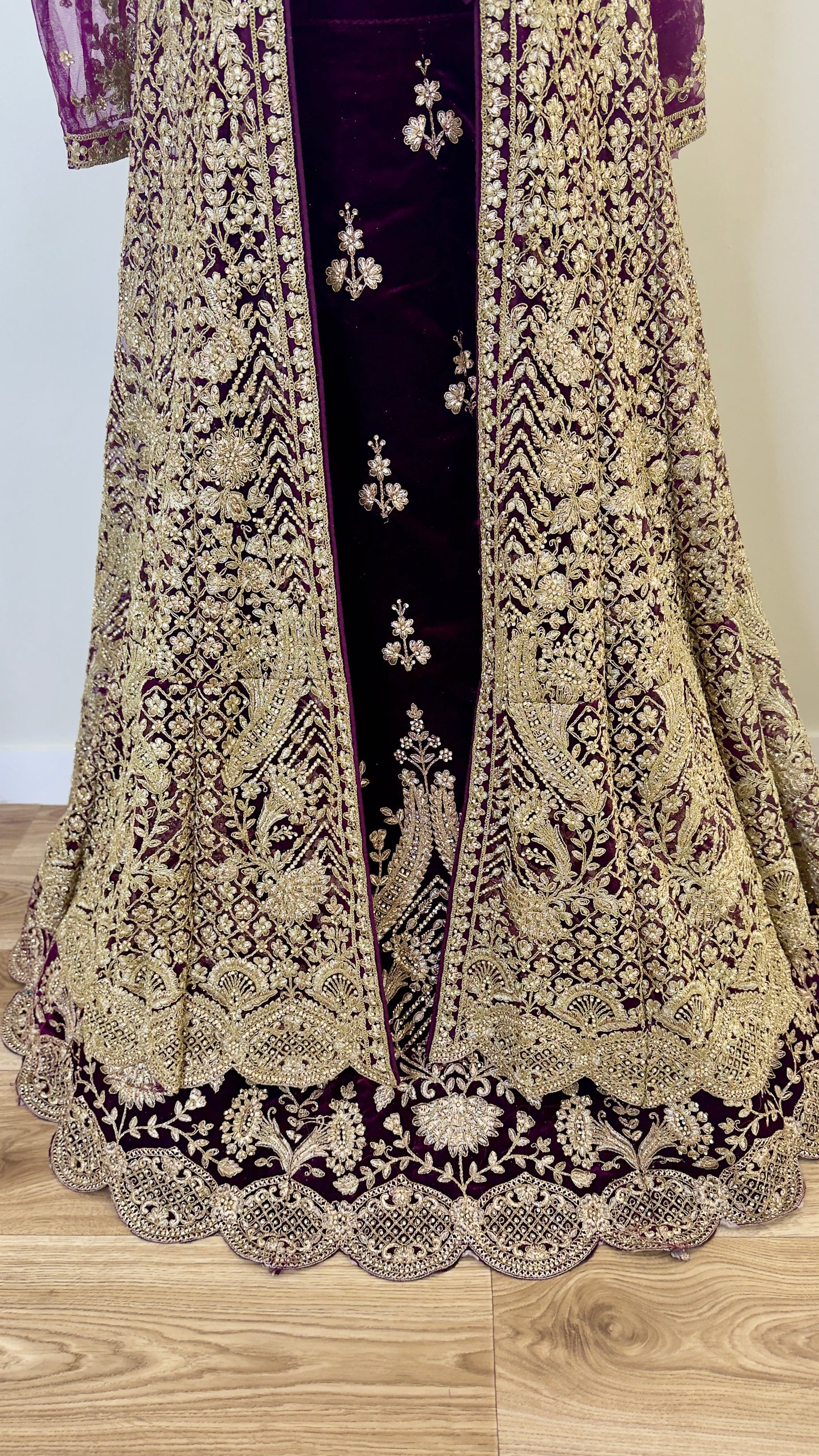 Decorative traditional outfit with intricate patterns on a wooden surface