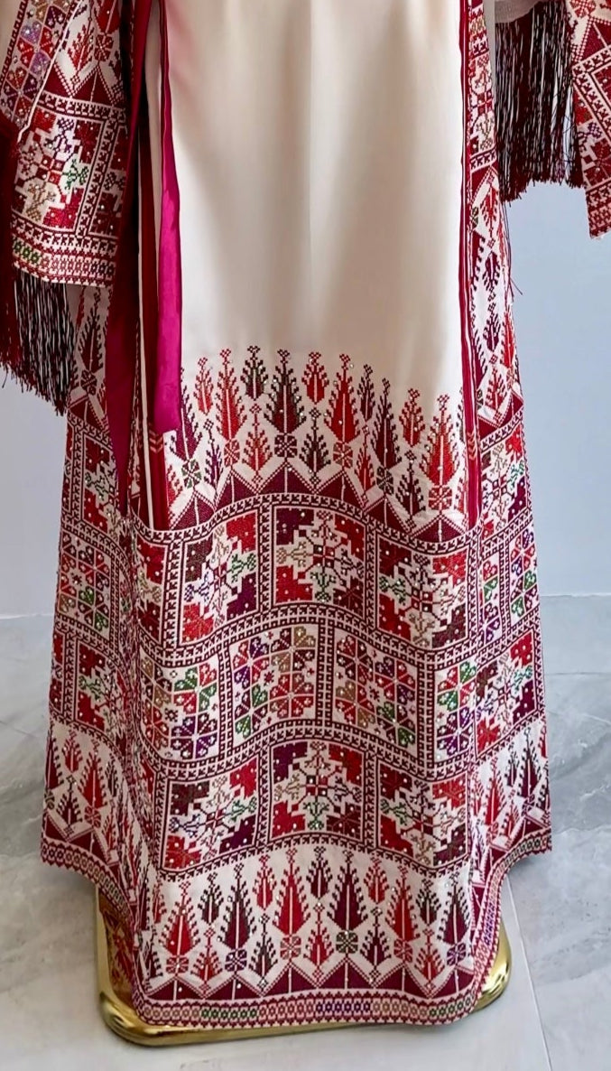 Close-up of colorful embroidered tatreez on front panel of cultural Palestinian dress