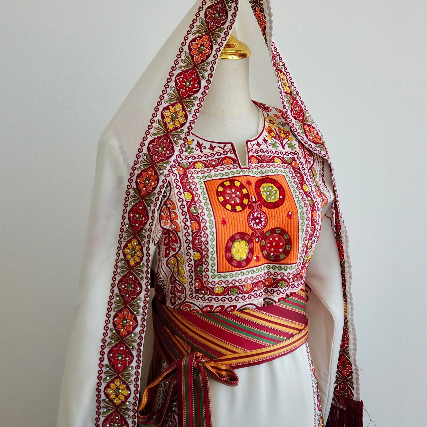 Detailed close-up of hand-embroidered chest panel on traditional Palestinian dress