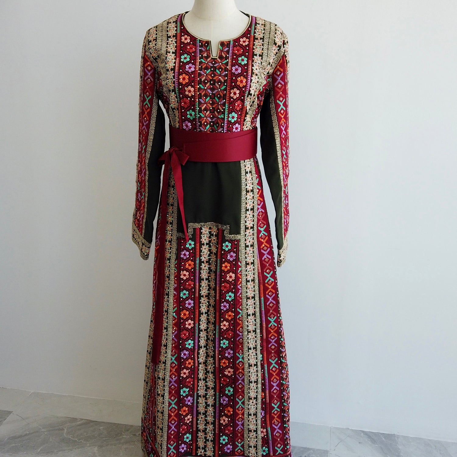 Full-length front view of cultural Palestinian thobe with belt and tatreez detail