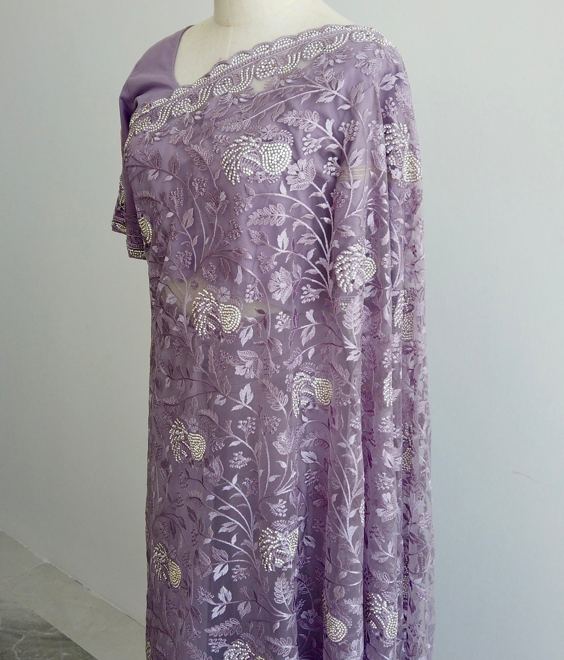 Close-up of ready to wear Saree, gold thread embroidery on sheer lavender net fabric