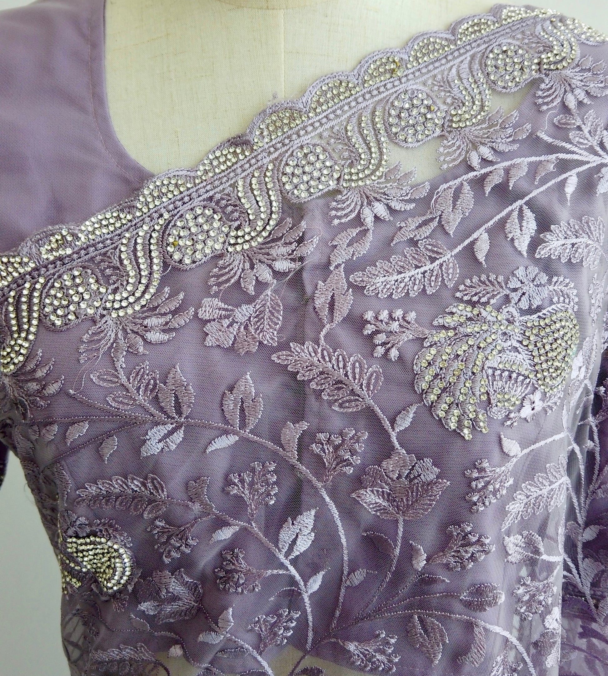 Flowing silhouette of purple embroidered saree with shimmering embellishments - premium soft net fabric enhances movement and elegance