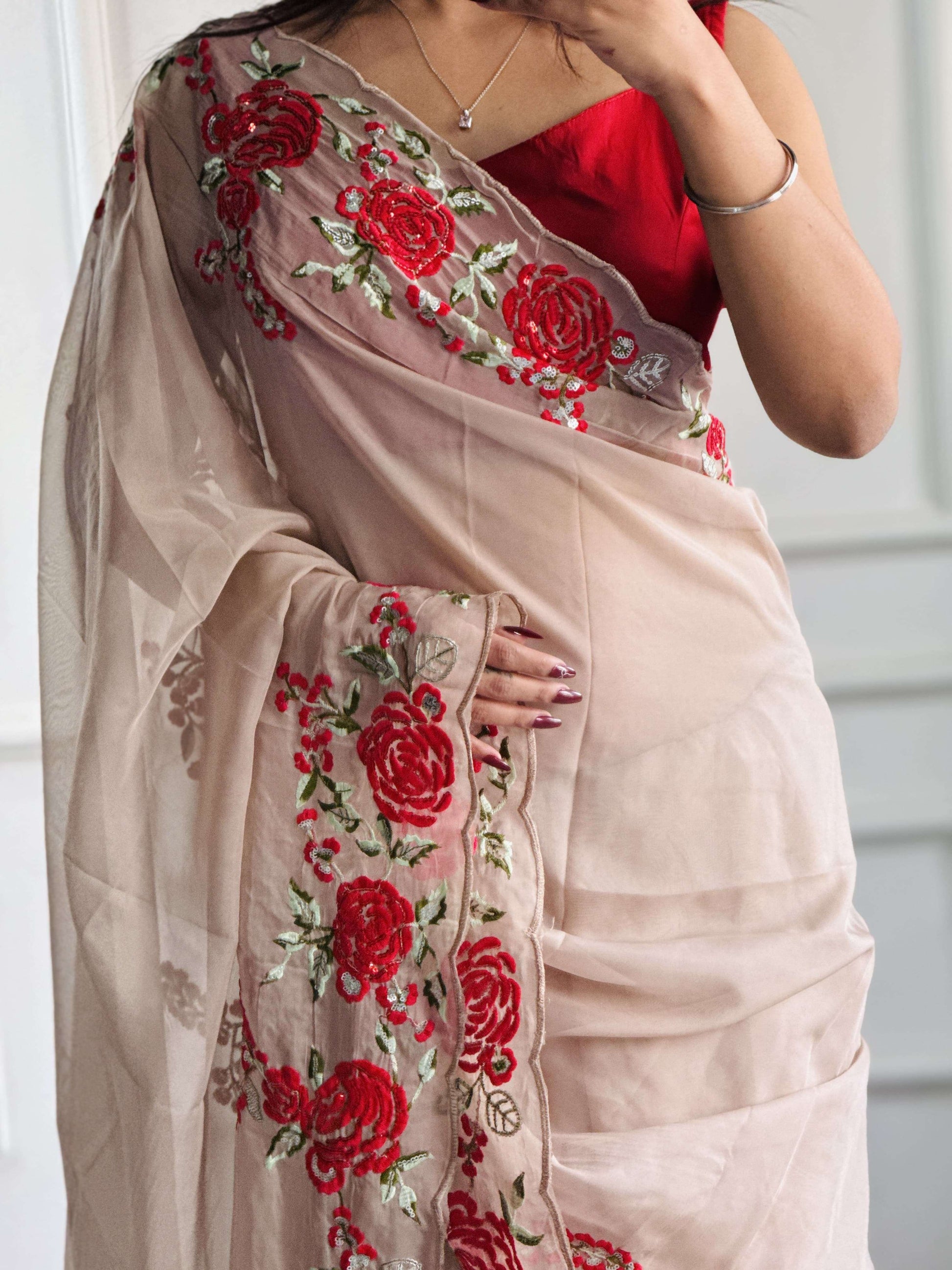 Intricate red thread embroidery on sheer beige organza saree - handcrafted patterns showcasing fine artisanal craftsmanship