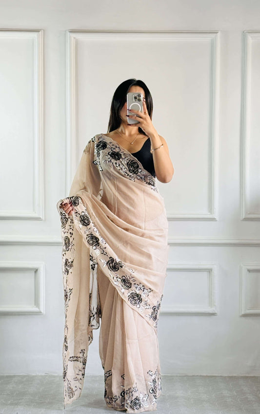 Luxury beige organza saree with intricate black embroidery - lightweight, sheer fabric with elegant draping for modern sophistication