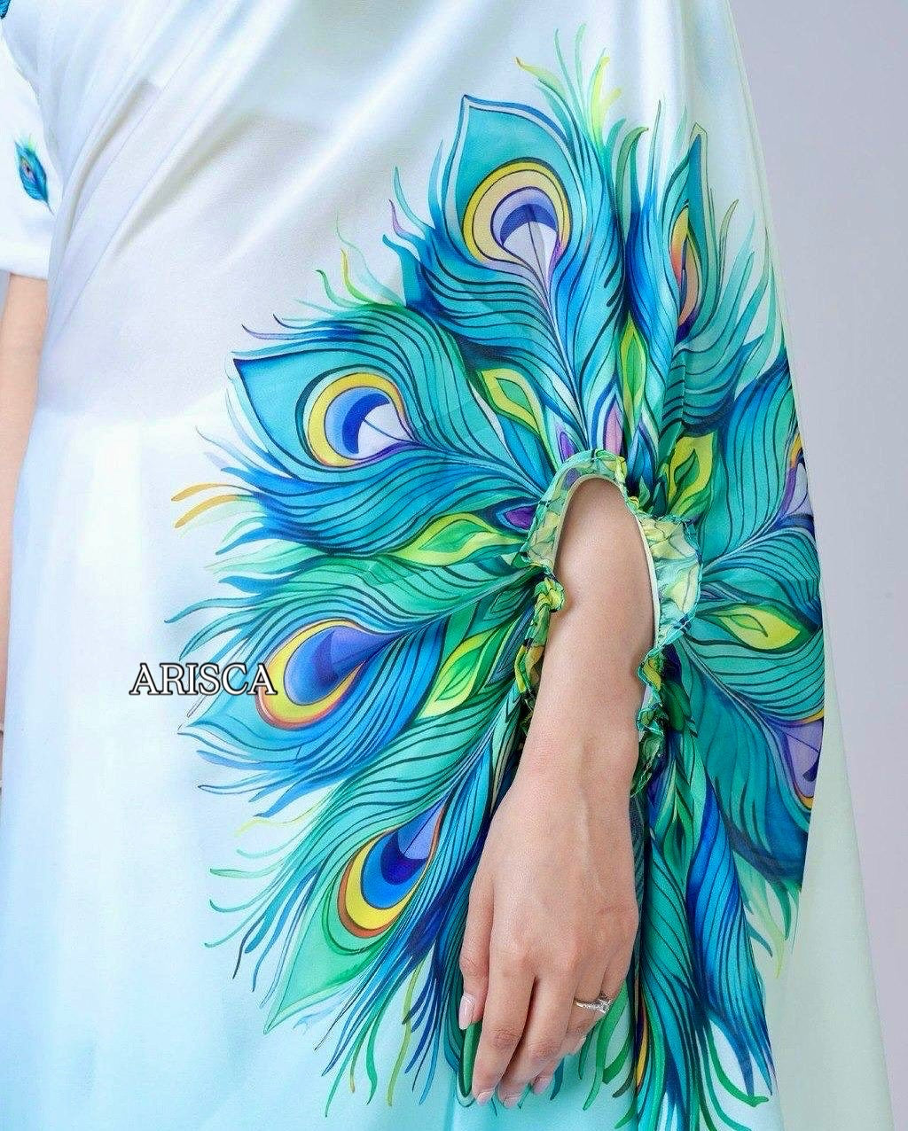 Colorful peacock feather design on a white ready to wear Saree with 'ARISCA' branding.