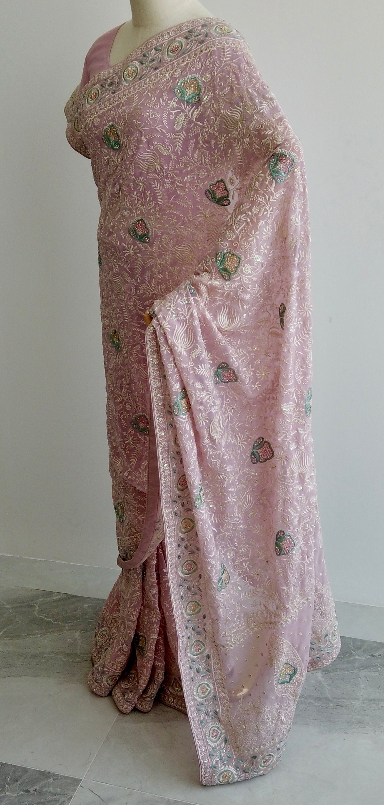 Pink Chikankari saree with floral embroidery on mannequin