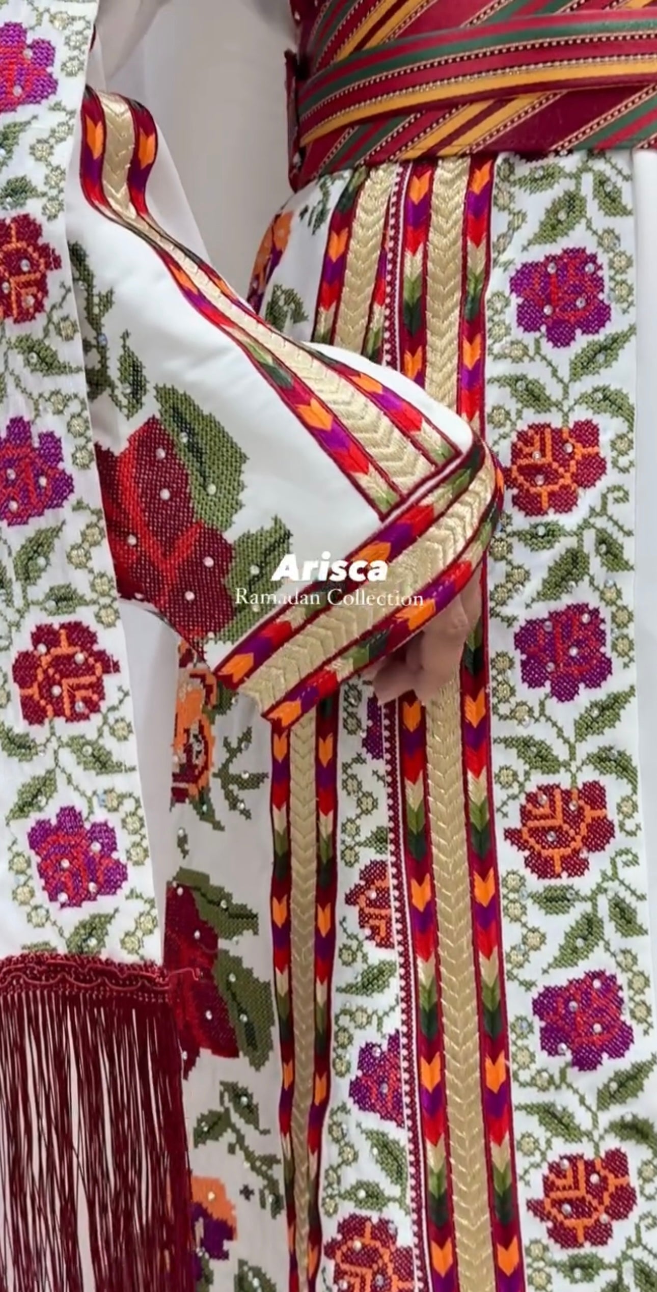 Side view highlighting wide embroidered sleeves and the flowing silhouette