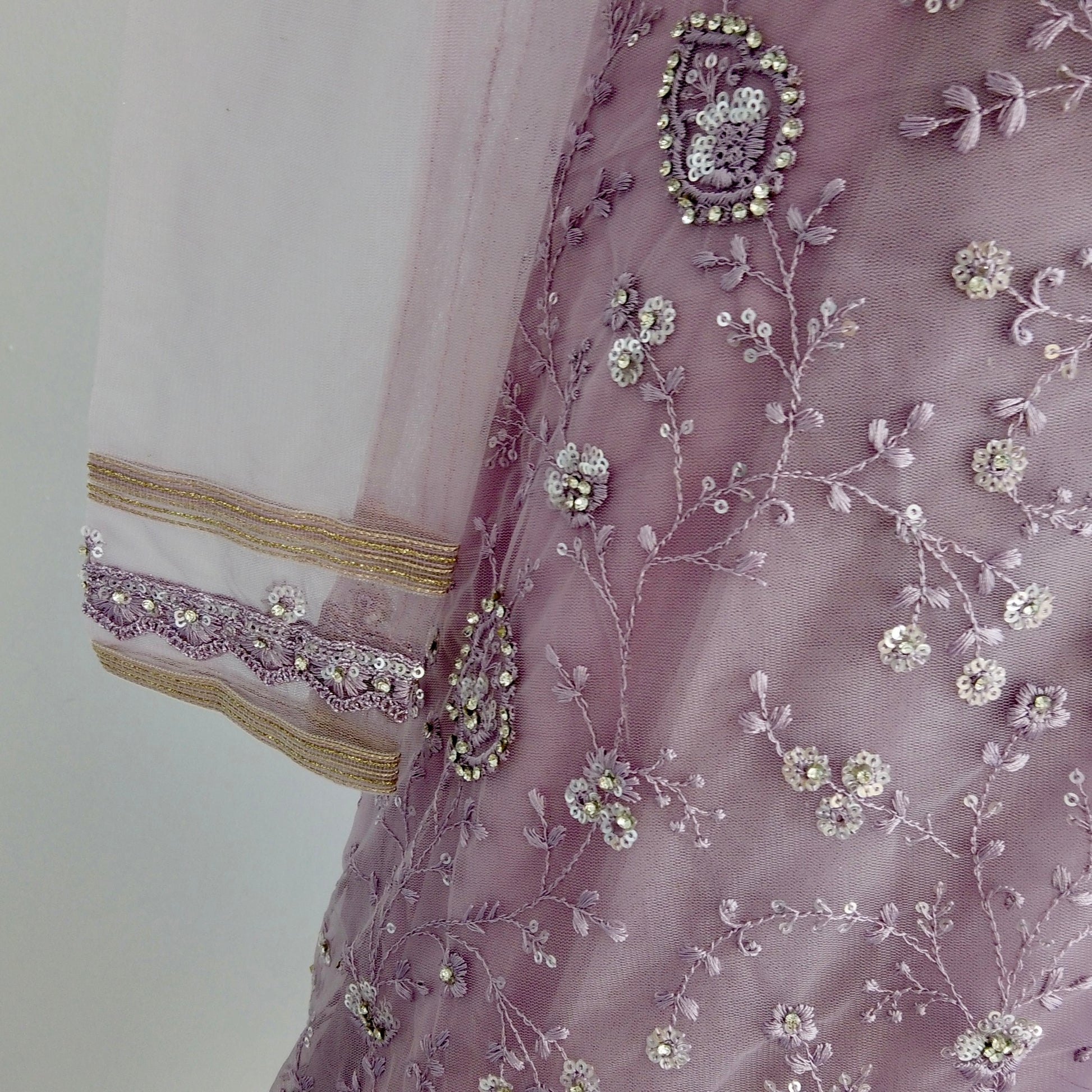 Hand-embroidered net saree with sequins and one sleeve blouse