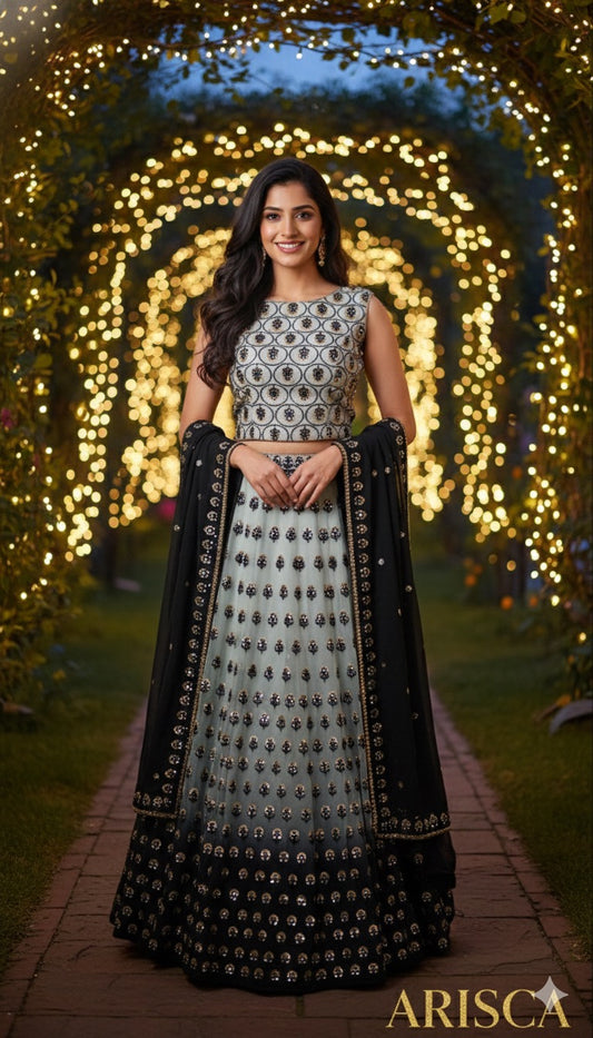Woman in traditional outfit with decorative patterns standing in front of a decorated archway.