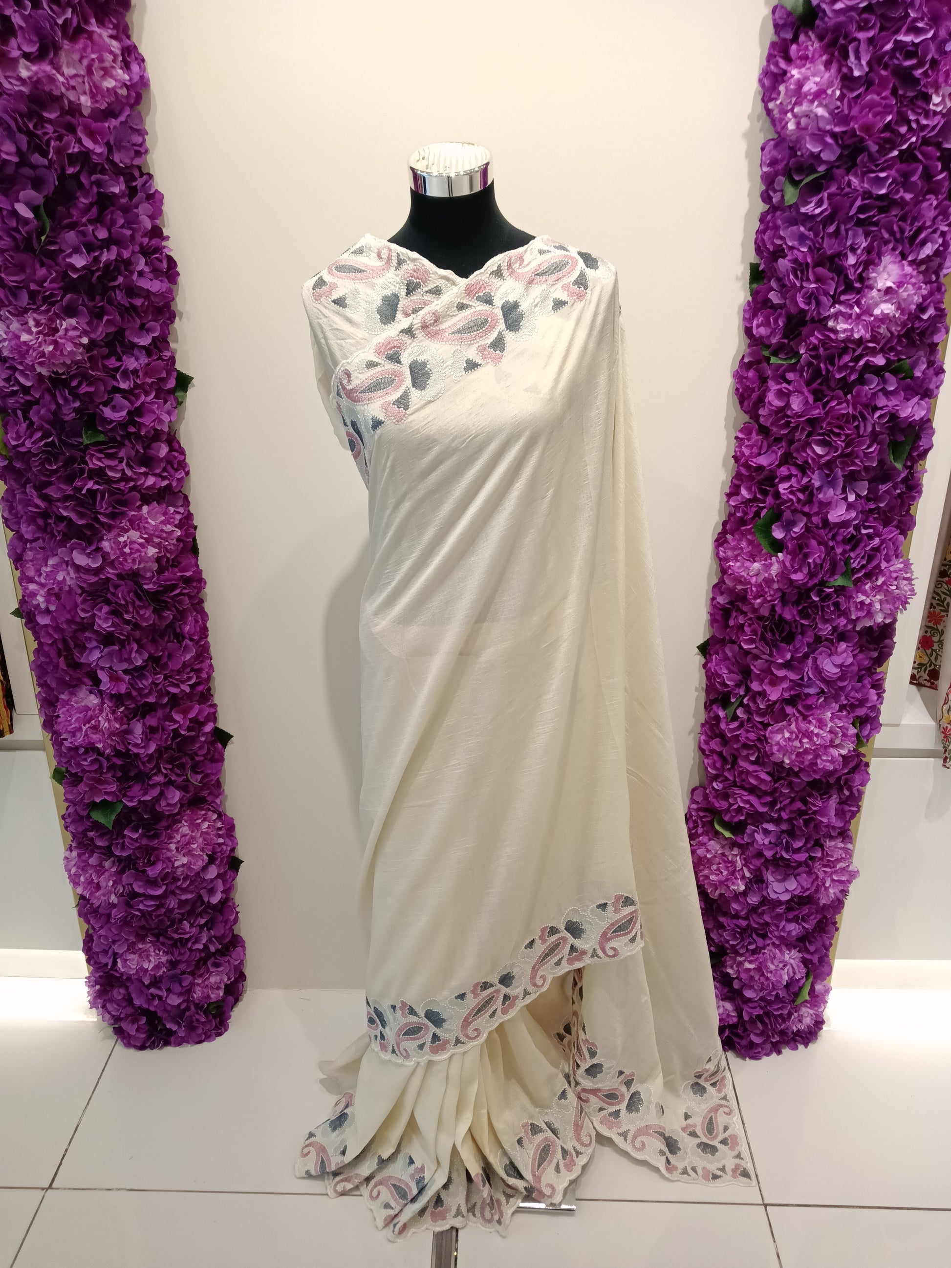 Elegant ivory cream / pearl white saree with delicate pink, silver-grey, and ivory embroidered border detailing. A timeless and sophisticated shade perfect for refined styling.