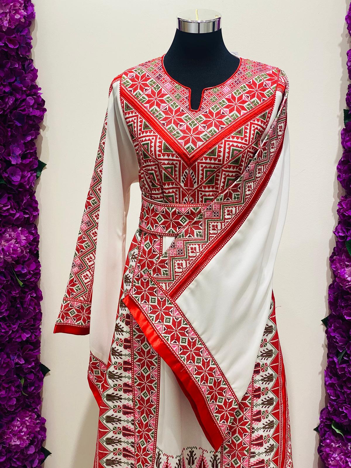 Luxury ivory Palestinian thobe at Arisca, detailed with red geometric embroidery.