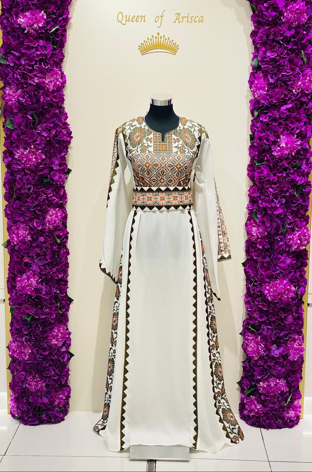 Ivory Palestinian-inspired thobe with geometric and floral embroidery at Arisca Qatar.