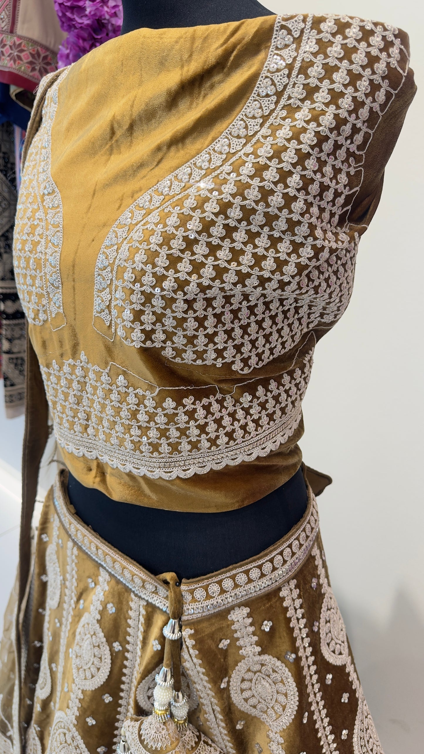 Traditional embroidered blouse with intricate patterns on a plain background