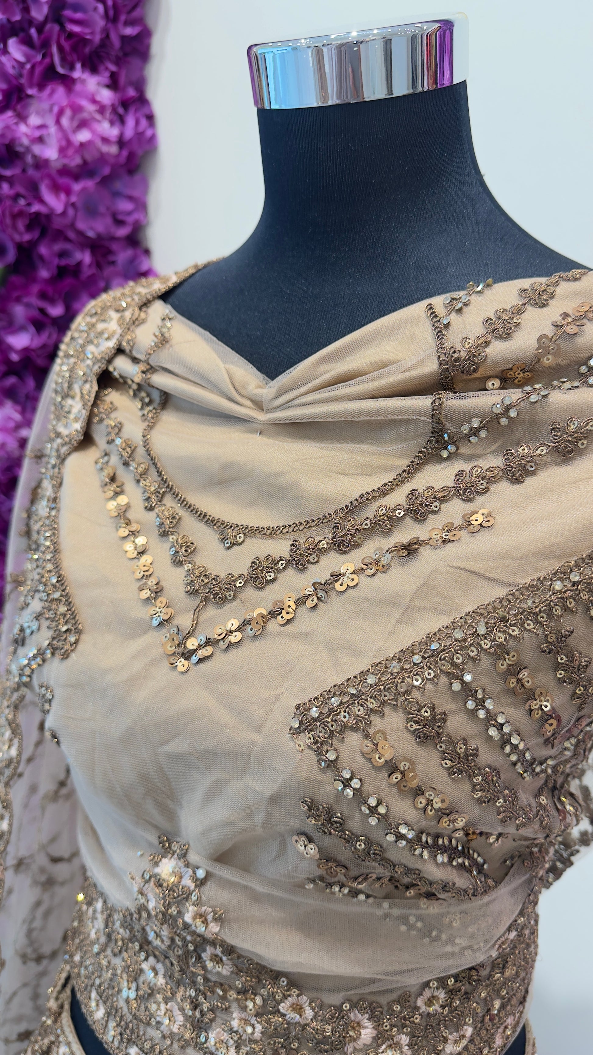 Golden Lehenga with intricate gold embroidery on a mannequin against a white background