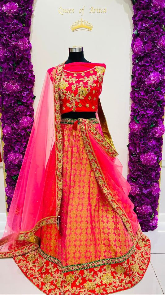A red and pink lehenga  with gold embroidery.