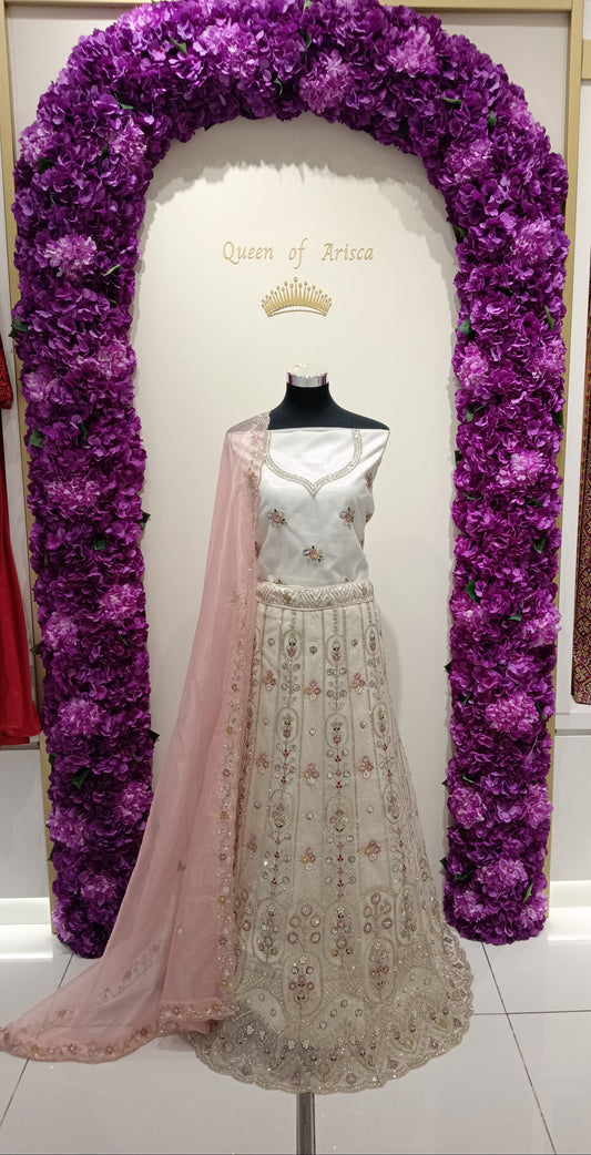 elegant ivory and blush pink lehenga is designed for women who appreciate soft luxury and timeless Indian bridal fashion. Featuring delicate floral embroidery.