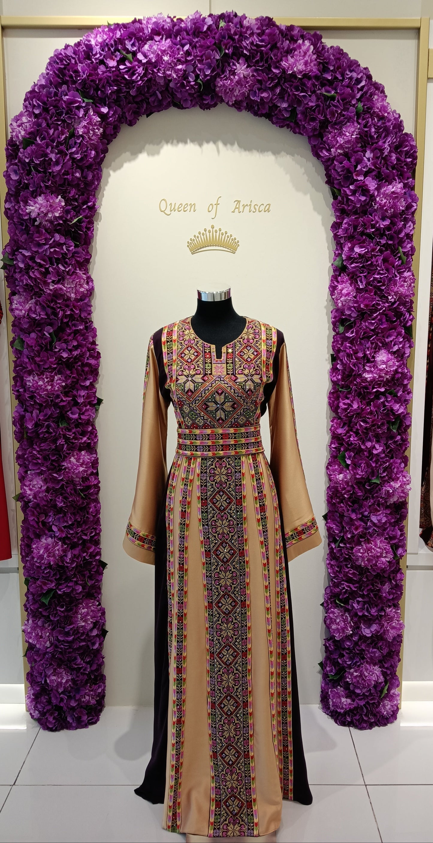 elegant Palestinian thobe in Qatar. Burgundy and champagne with floral embroidery