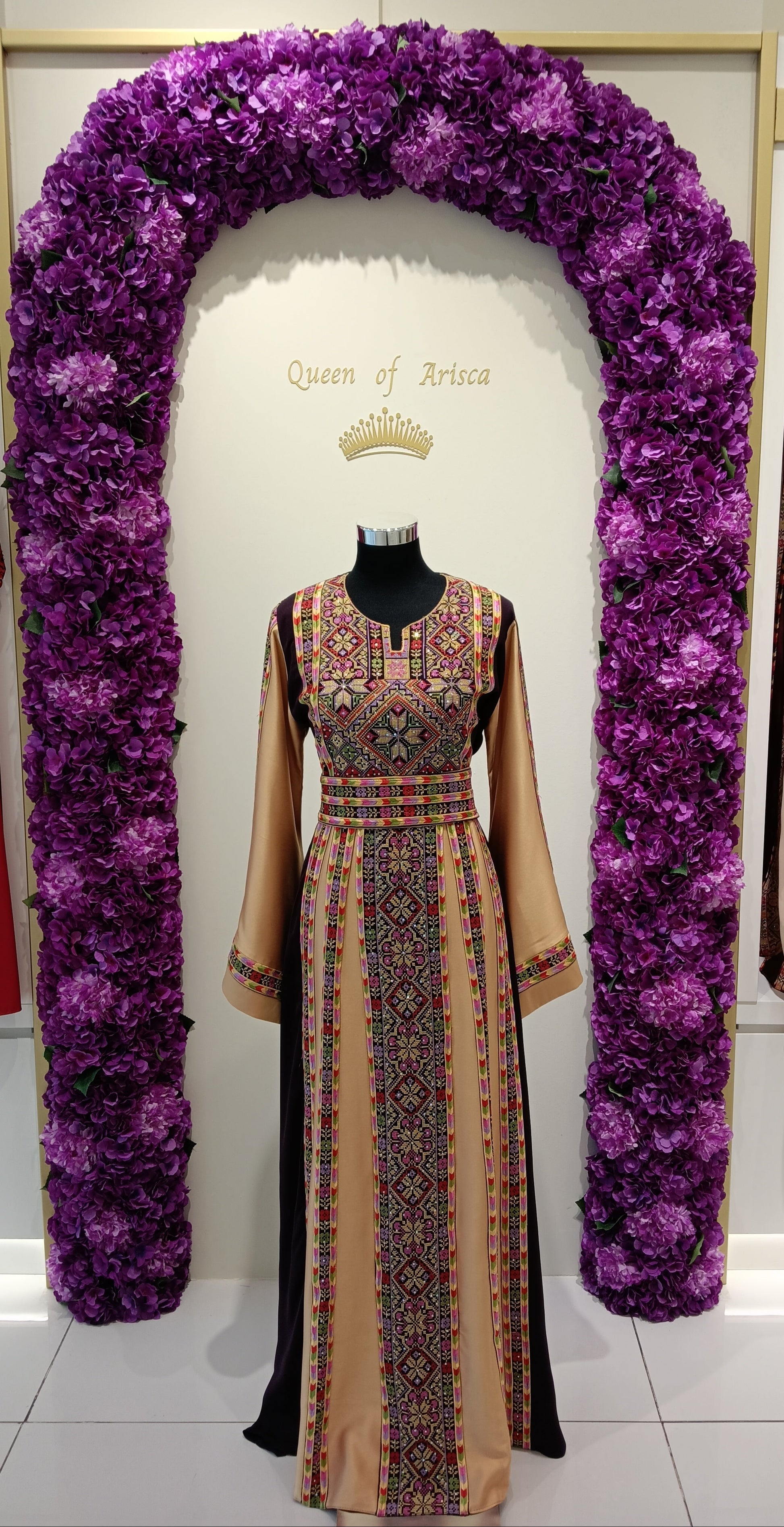elegant Palestinian thobe in Qatar. Burgundy and champagne with floral embroidery