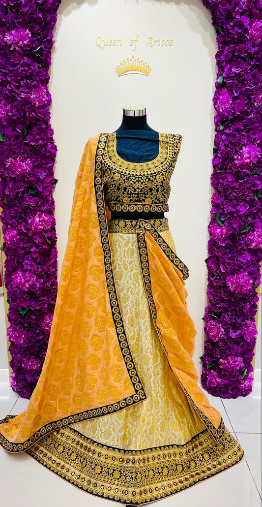 A traditional Indian lehenga set , featuring a yellow and gold embroidered lehenga choli with a matching dupatta.