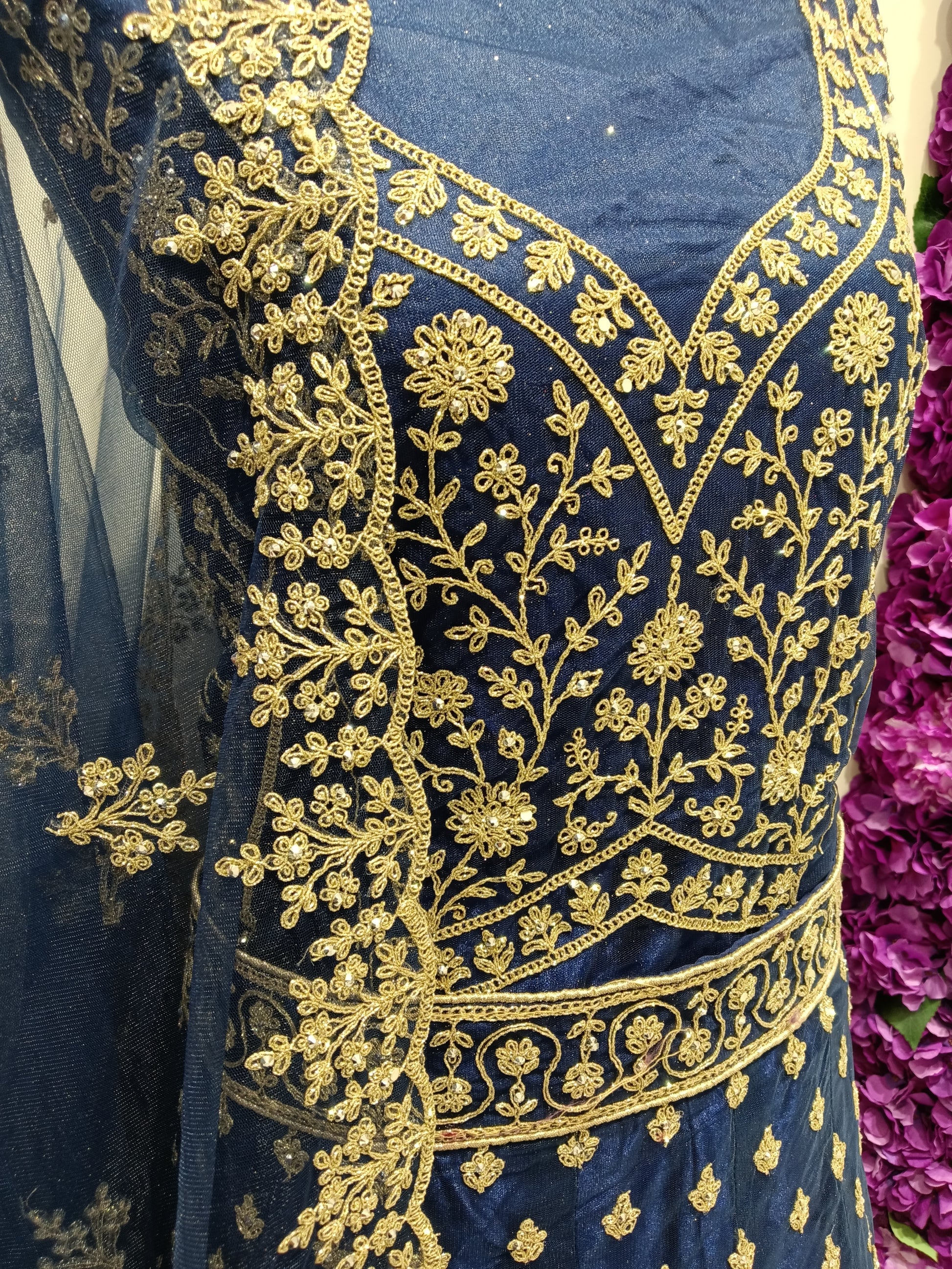 regal navy blue lehenga with dense antique gold zari embroidery.