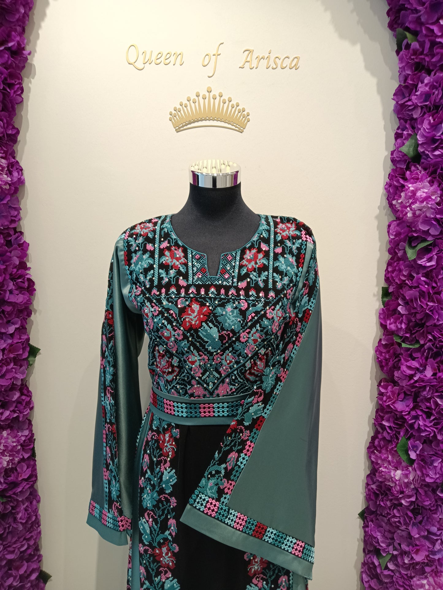 Palestinian thobe, trich deep black, beautifully contrasted with intricate traditional embroidery in teal, turquoise, blush pink, and subtle red tones | Qatar