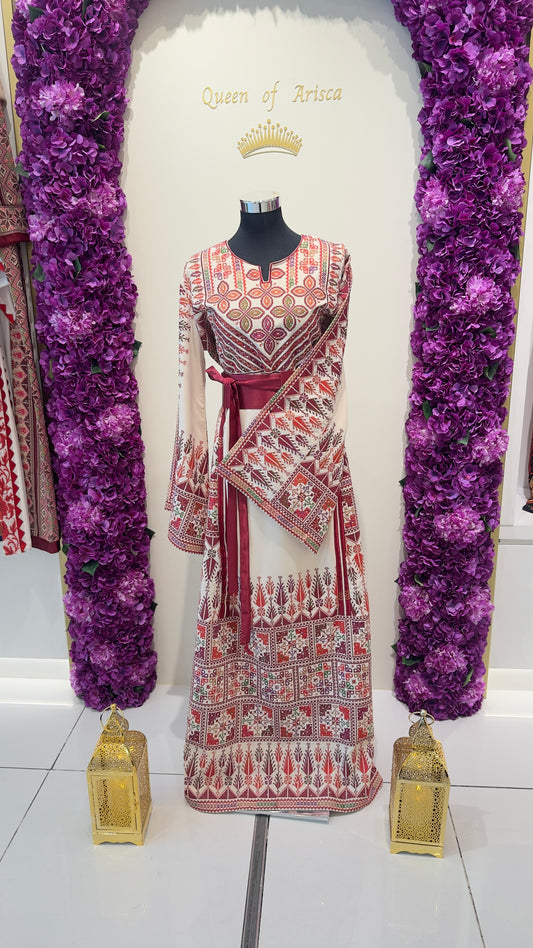 Mannequin wearing a patterned dress with decorative elements on a white background