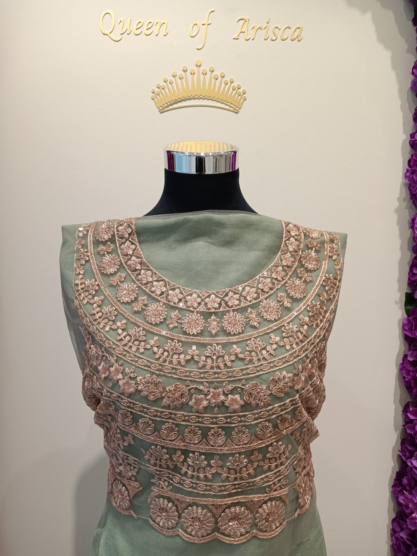 modern royal esthetic saree blouse,base color is a muted sage green / pastel pistachio, The embroidery is done in a rose gold / antique gold tone, creating a beautiful contrast that looks luxurious without being too loud.
