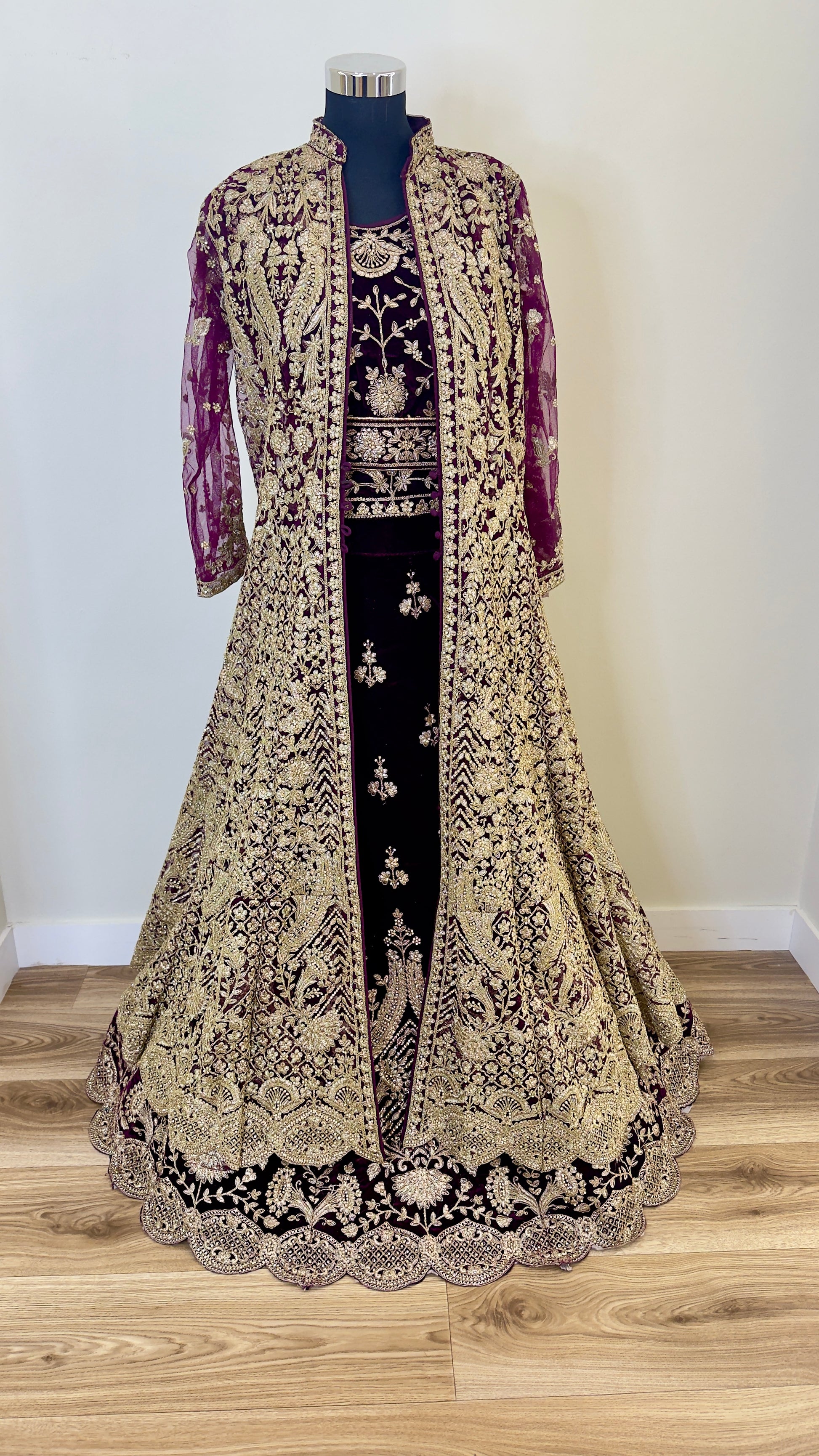 Traditional embroidered lehenga on a mannequin against a plain background