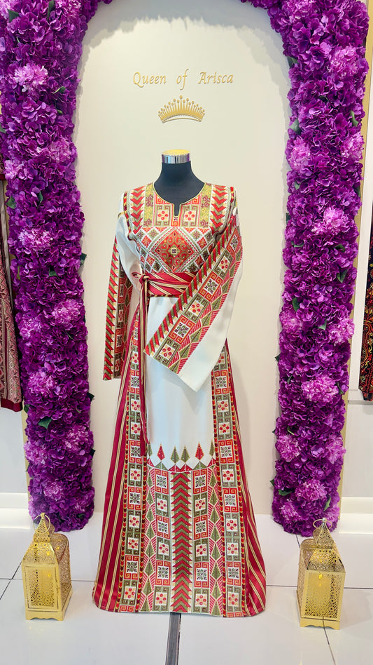 Mannequin wearing a patterned dress with decorative elements on a white background