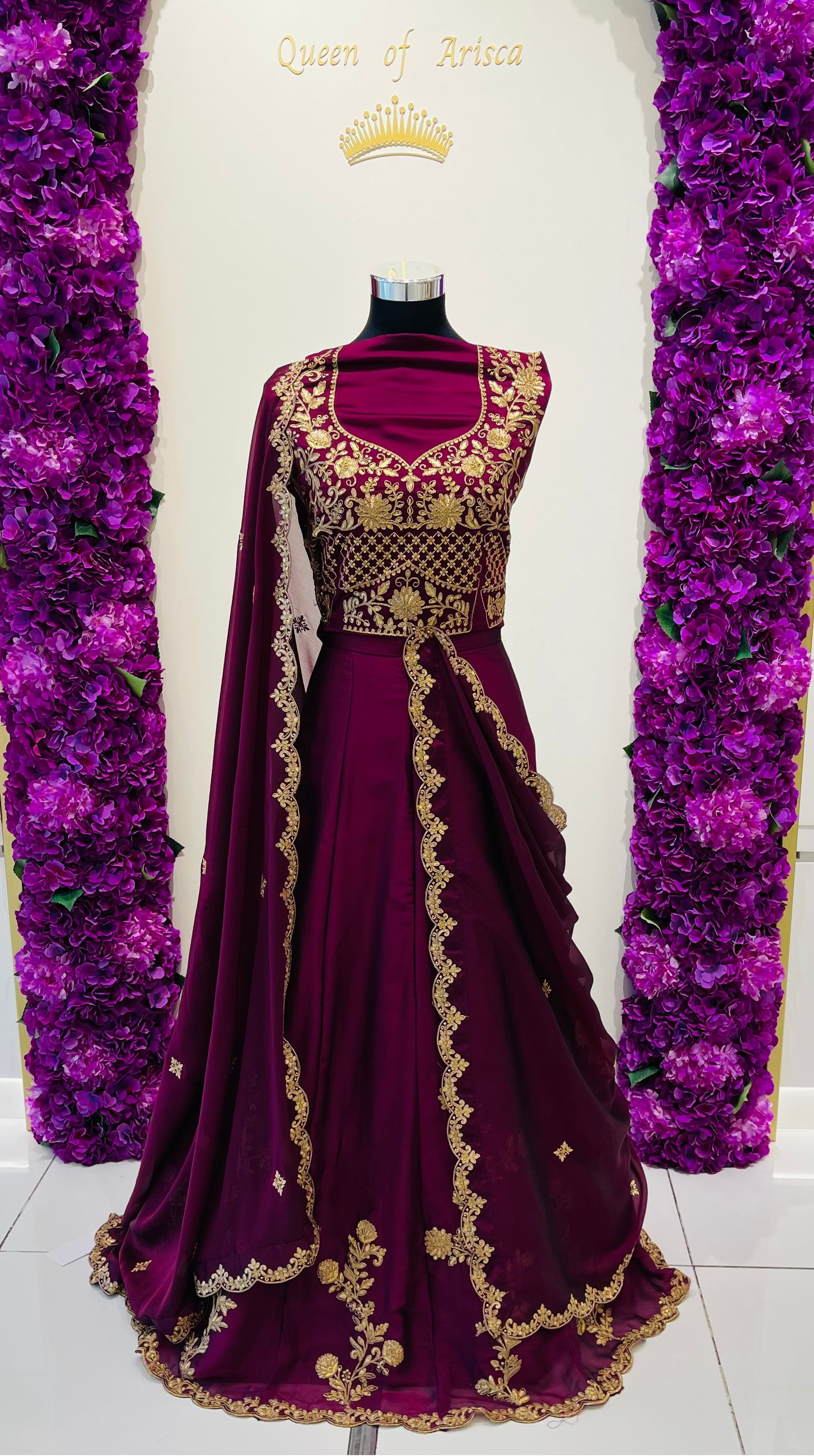 A deep purple velvet party wear lehenga with intricate gold embroidery.
